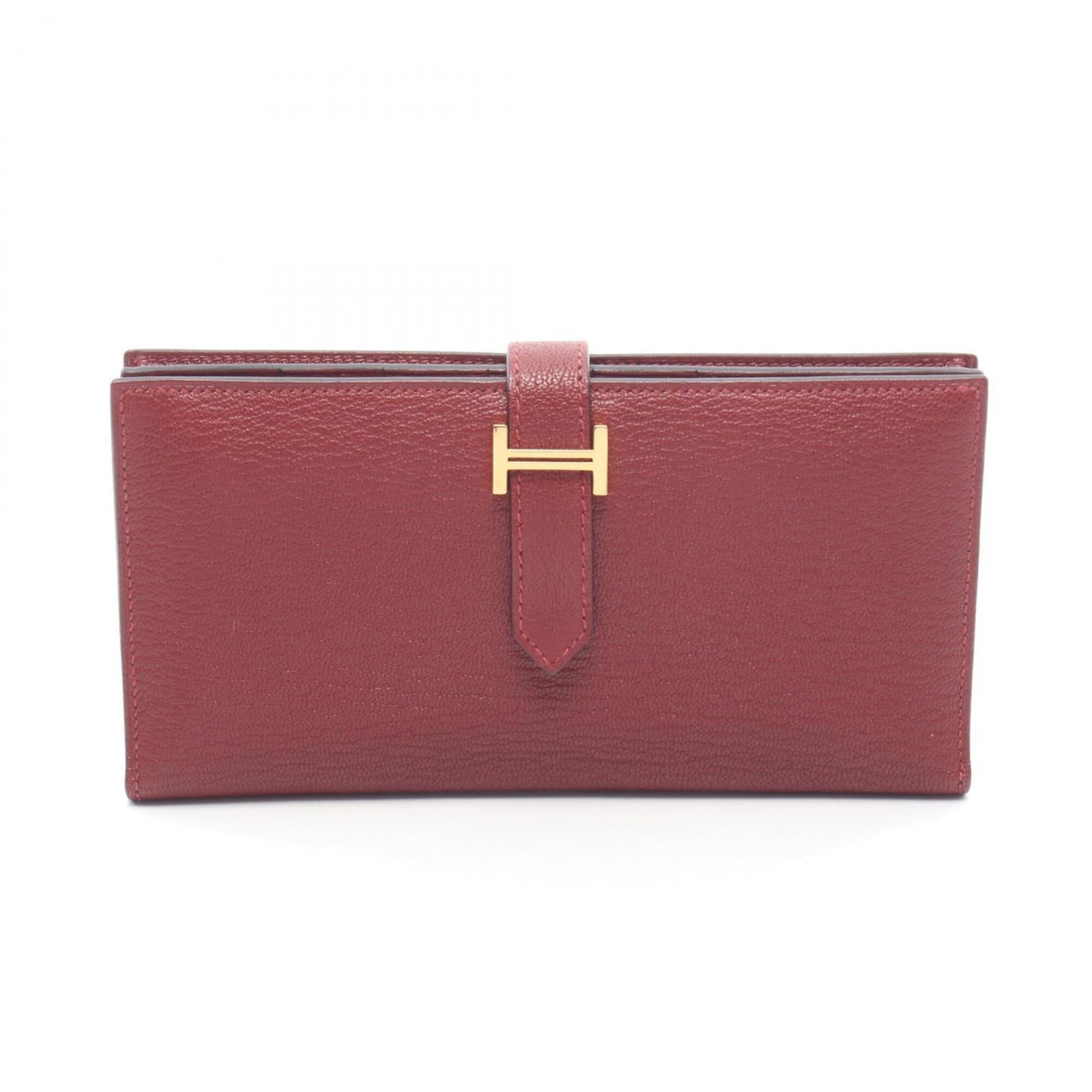 Chevre Leather Bi Fold Hermes Wallet: Chevre Leather Bi Fold Hermes Wallet Chevre leather, a rich Bordeaux and Rouge color, adorns this elegant bi-fold wallet from the iconic Hermes brand. With its sleek 9cm x 17.5cm x 2cm dimensions, thi