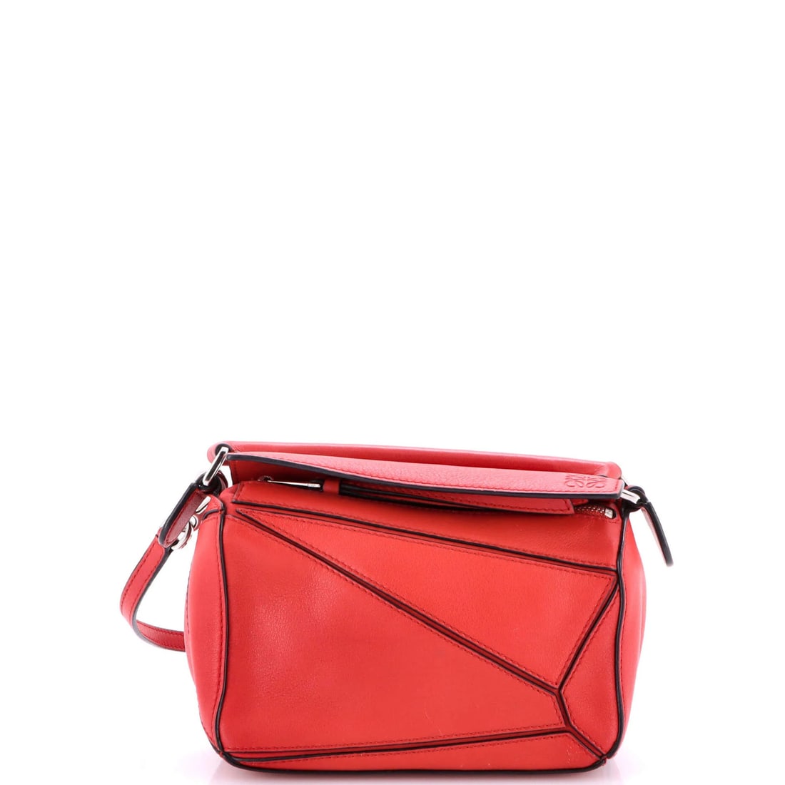 Loewe Puzzle Bag Leather Mini: Loewe Puzzle Bag Leather Mini The Loewe Puzzle Bag Leather Mini is a stylish and compact cross body bag, featuring a bold red exterior and neutral interior. With its 15.5-23.5" adjustable strap, this