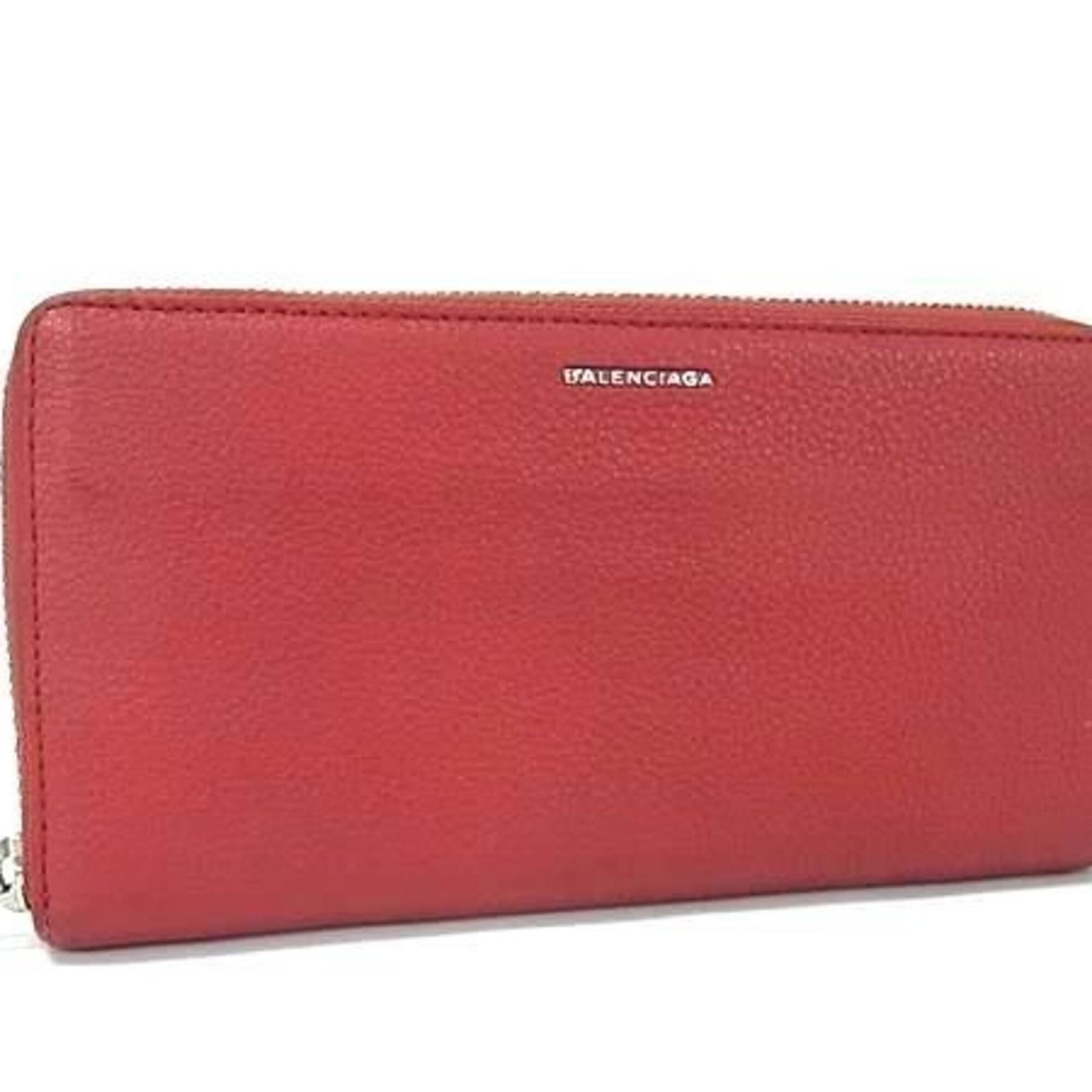 Long Wallet Leather Bi Fold Balenciaga: Long Wallet Leather Bi Fold Balenciaga Red leather bi-fold wallet from Balenciaga, featuring a long design with a zipper closure. Made from high-quality leather, this wallet measures 10cm x 19cm x