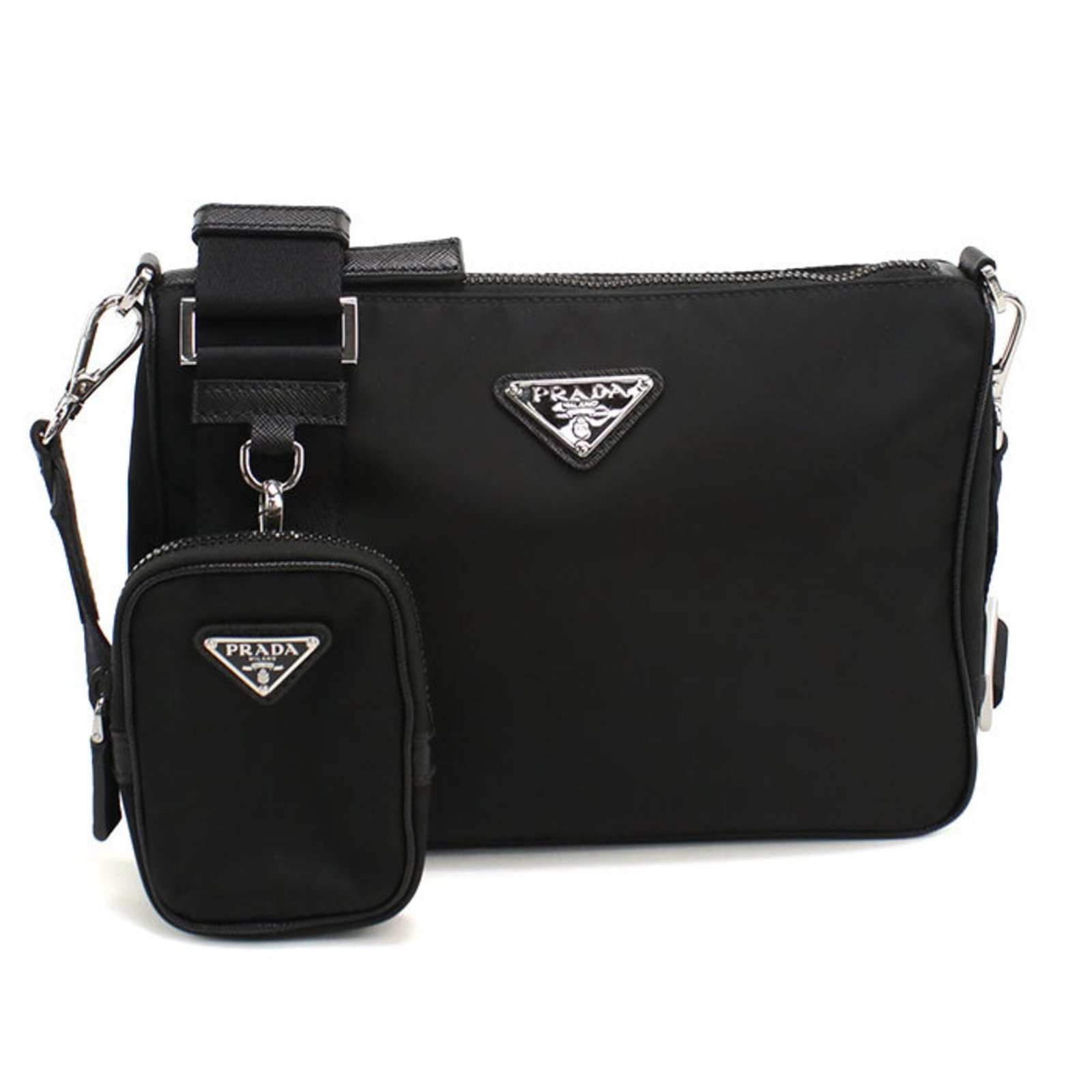 Shoulder Bag Nylon: Shoulder Bag Nylon The Prada Country shoulder bag is crafted from durable nylon, featuring a sleek black design with silver hardware. Measuring 18.5cm x 24.5cm x 6cm, this stylish bag is perfect for