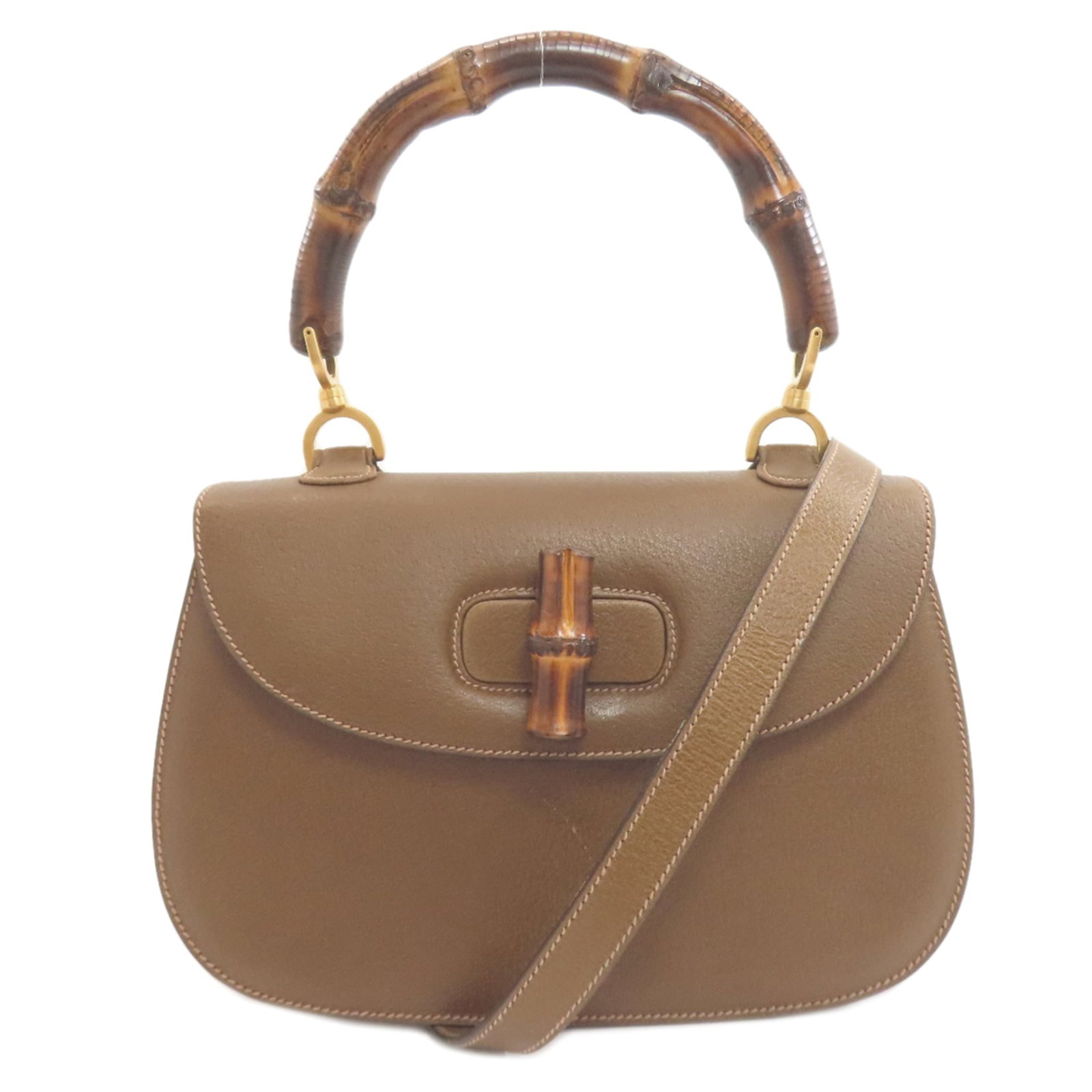 Handbag Leather Gucci: Handbag Leather Gucci Handbag made from high-quality leather, featuring a classic design with a brown calfskin finish. The bag includes a mirror and adjustable shoulder strap for added convenience.