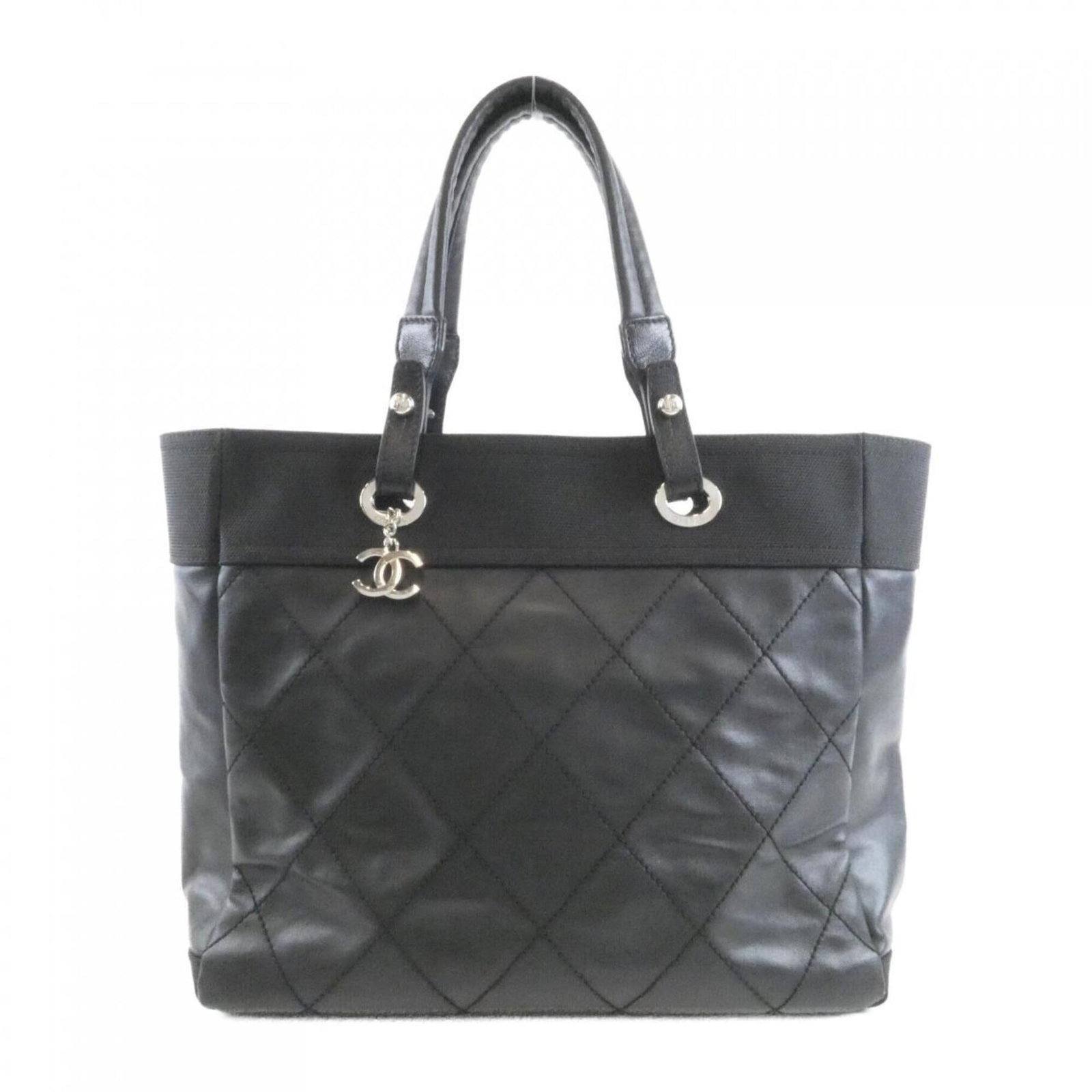Handbag Canvas by Chanel: Handbag Canvas by Chanel Canvas by Chanel is a black handbag with a canvas material, measuring 29cm x 35cm x 15cm. The bag's size and color make it a distinctive accessory, while its canvas material