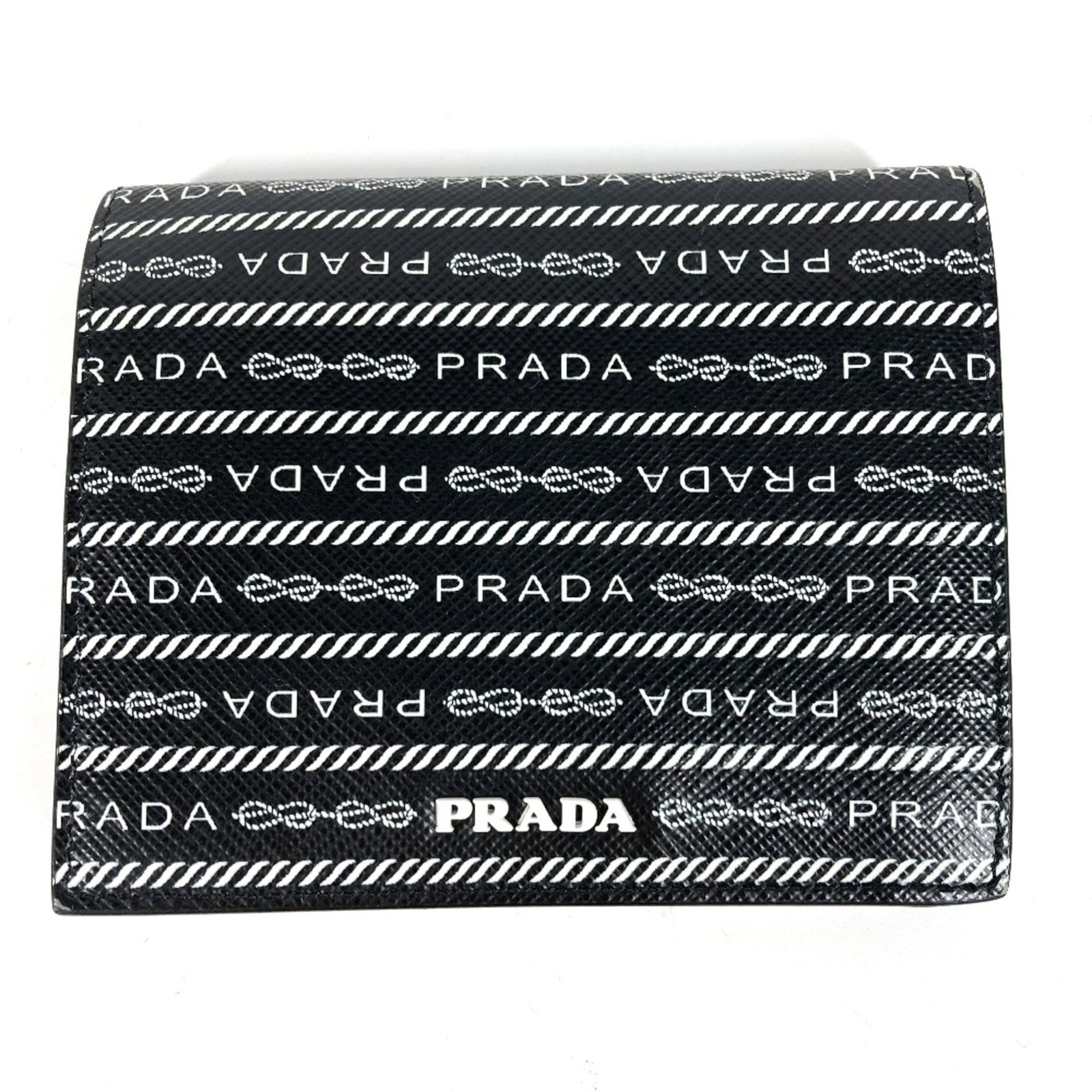 Bi fold leather wallet: Bi fold leather wallet Bi-fold leather wallet with a sleek black finish, measuring 11cm x 9cm. The Prada 1MV204 model boasts a classic design, showcasing high-quality leather construction. Item
