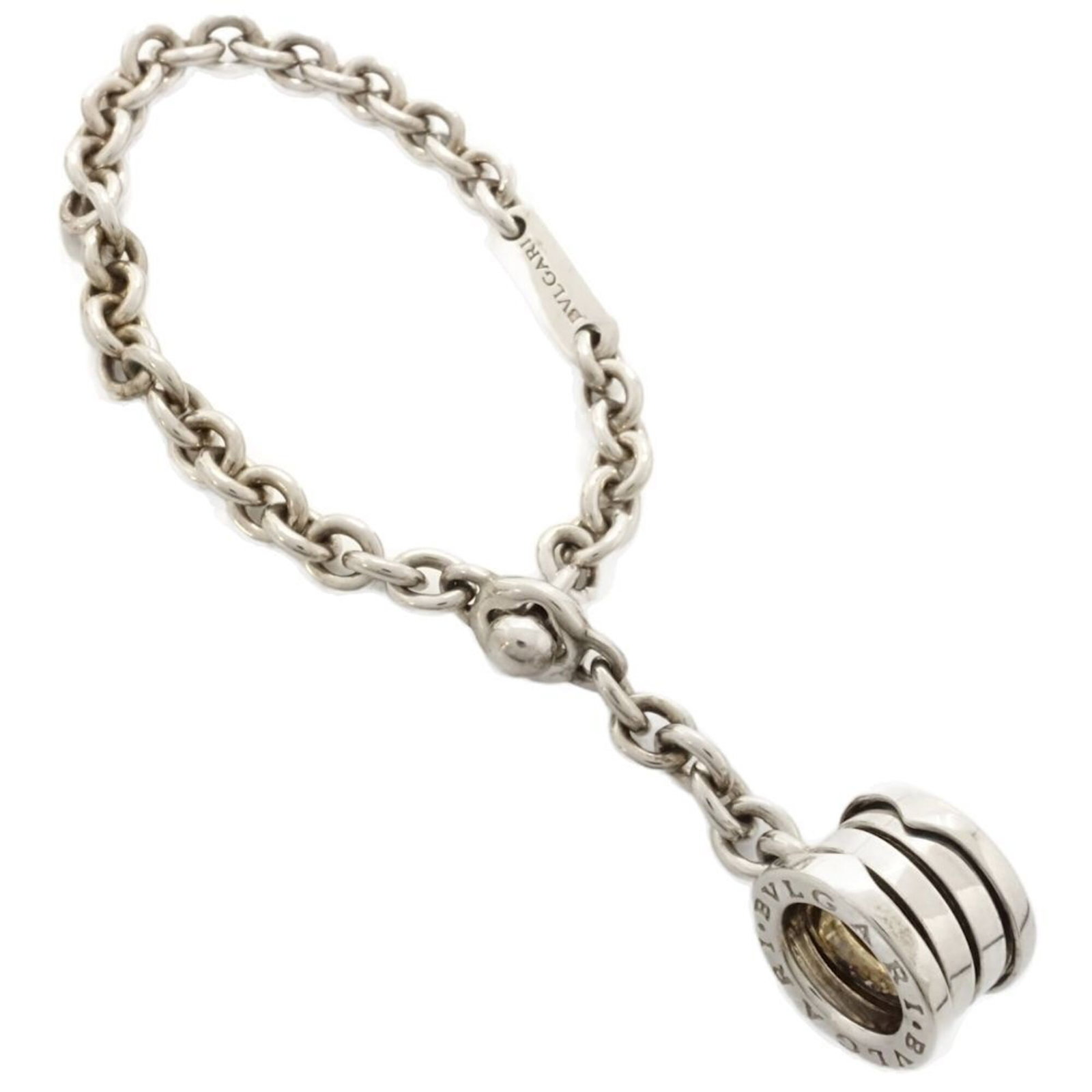 Key Chain Silver Bvlgari 925: Key Chain Silver Bvlgari 925 Silver 925, the iconic Italian luxury brand Bvlgari is represented by this elegant key chain, crafted from high-quality silver. The B.zero1 line adds a touch of