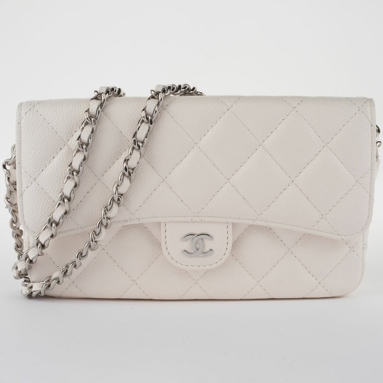 Caviar Leather Chanel Shoulder Bag: Caviar Leather Chanel Shoulder Bag Caviar leather adds a luxurious touch to this Matelasse Chanel shoulder bag, with its crisp white color and silver hardware standing out. Measuring 11cm x 18cm x 4.5