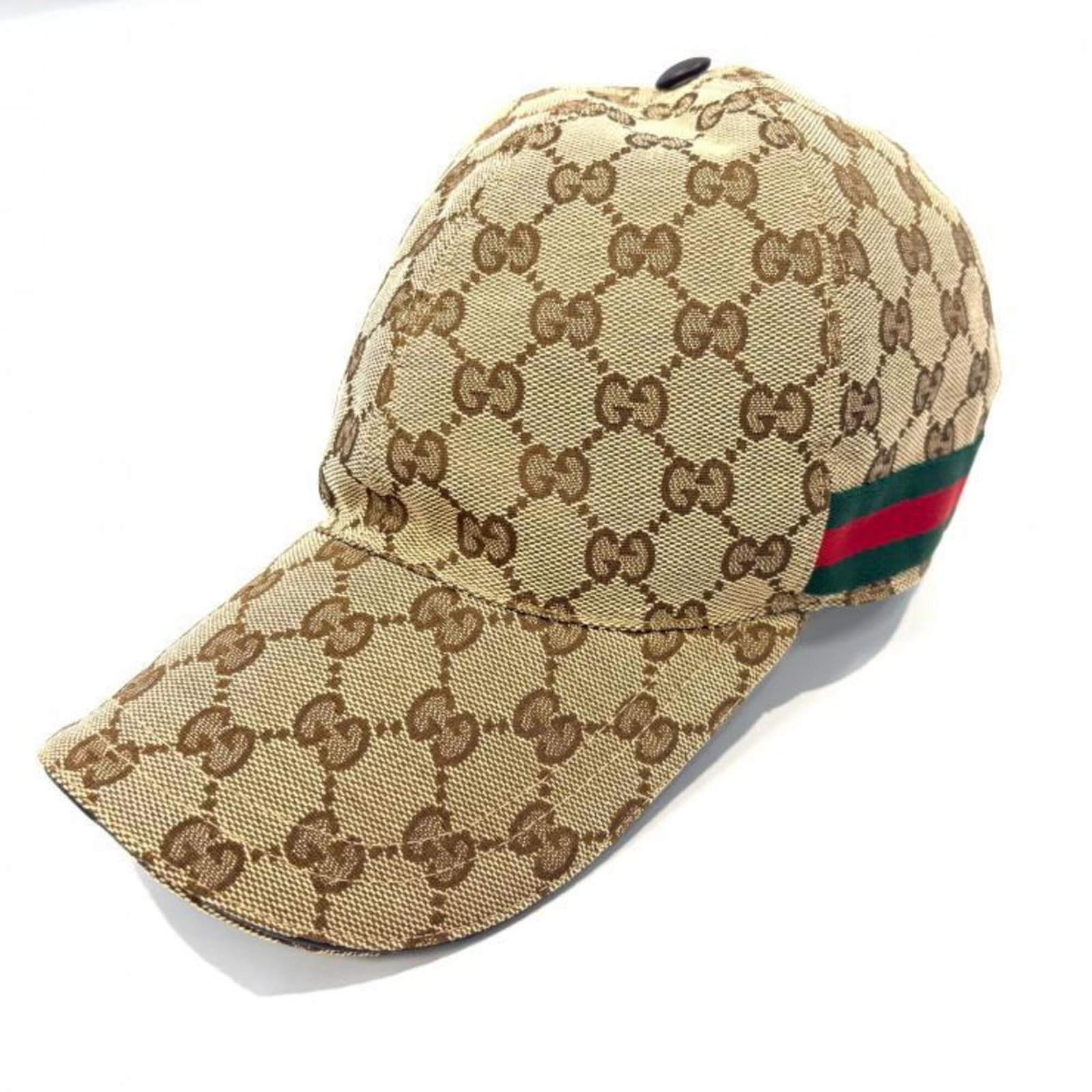 Canvas Leather Gucci Cap: Canvas Leather Gucci Cap Canvas and leather combine in this Gucci cap, featuring a classic design. The brown color and combination of materials make for a stylish accessory. A signature is present on