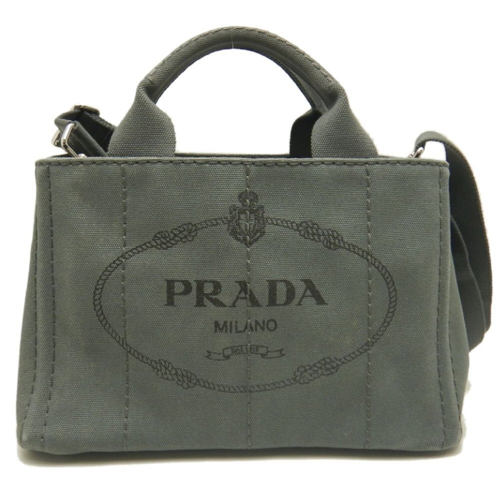 Canvas Prada Tote: Canvas Prada Tote Canvas Prada Tote in Ardesia Color, Open Closure, and Silver Hardware. This 18cm x 28cm x 15cm tote bag is made from canvas material and features a signature. The bag's strap length