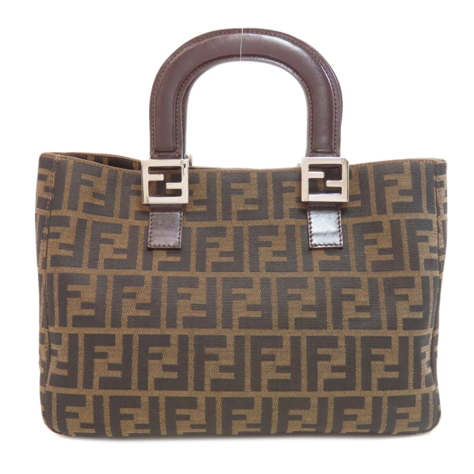 Handbag Canvas By Fendi: Handbag Canvas By Fendi Canvas by Fendi is a brown handbag made from canvas, measuring 21cm x 34cm x 12cm. The bag bears a signature, and its canvas material provides a unique texture. This handbag is
