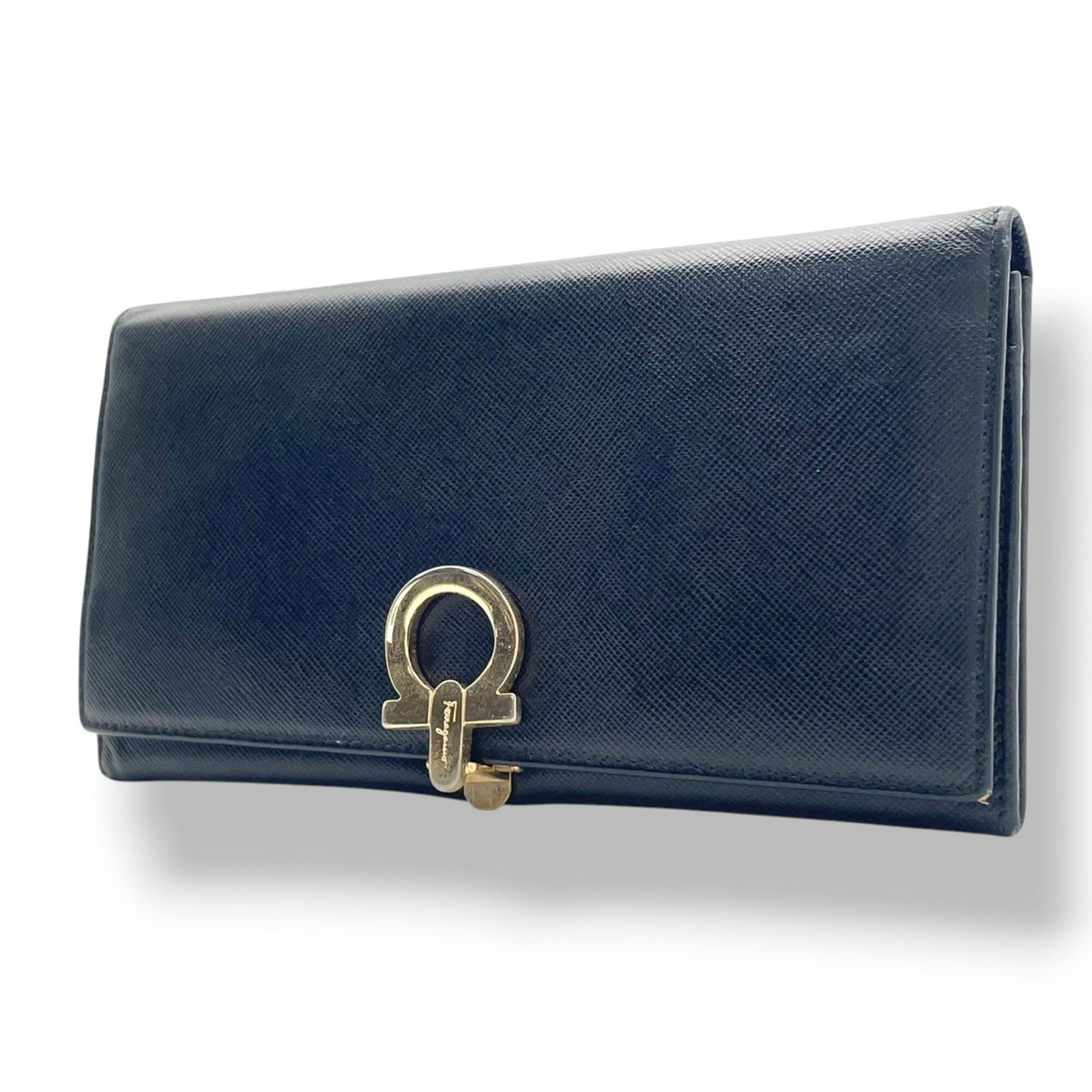 Salvatore Ferragamo Long Wallet (Bi-Fold) Leather: Salvatore Ferragamo Long Wallet (Bi-Fold) Leather Black leather bi-fold wallet from Salvatore Ferragamo, Italy, measuring 10cm x 19cm x 1.5cm. This long wallet features high-quality leather