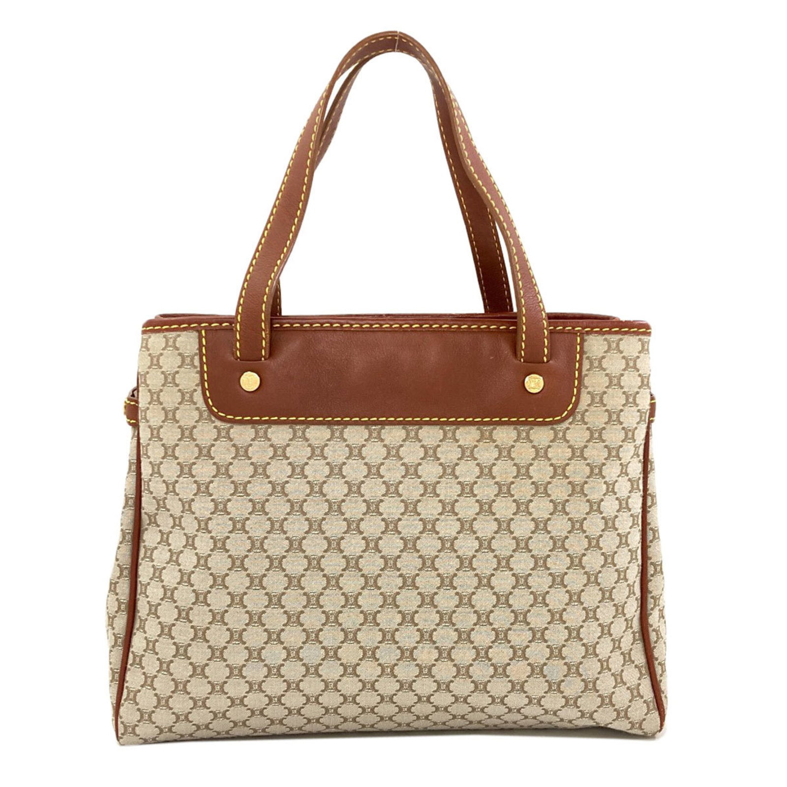 Handbag Canvas: Handbag Canvas Canvas Handbag from Celine's Macadam Line. This brown canvas handbag features a signature and measures 21cm x 26.5cm x 9cm. Its sturdy design and classic style make it a practical and