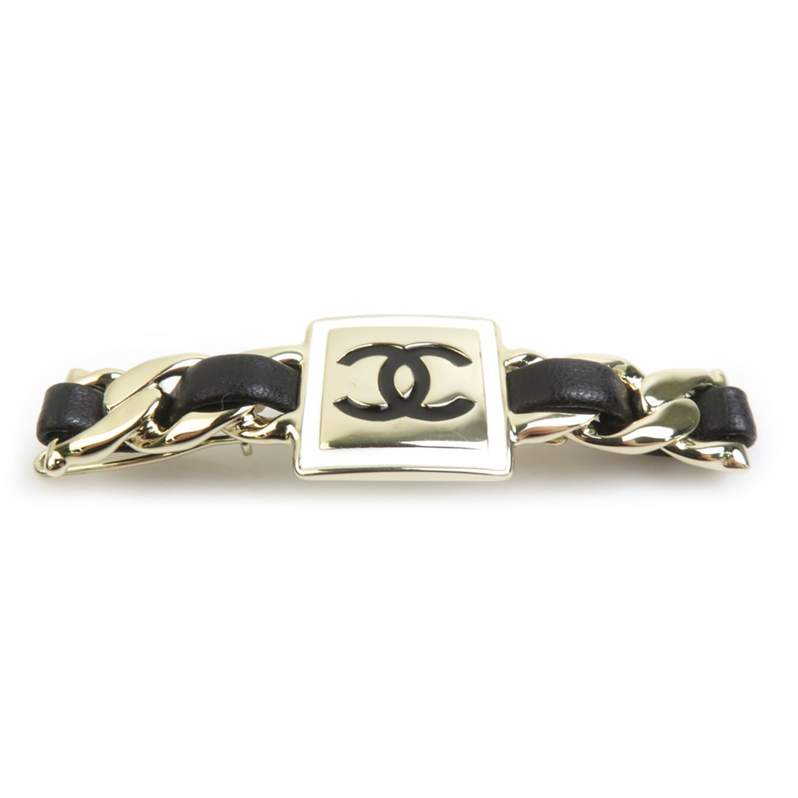 Chanel Metal Leather Hair Clip: Chanel Metal Leather Hair Clip Chanel's sleek metal leather hair clip boasts a chic black finish, elegant gold accents, and a sophisticated white leather detail. Made from high-quality materials,