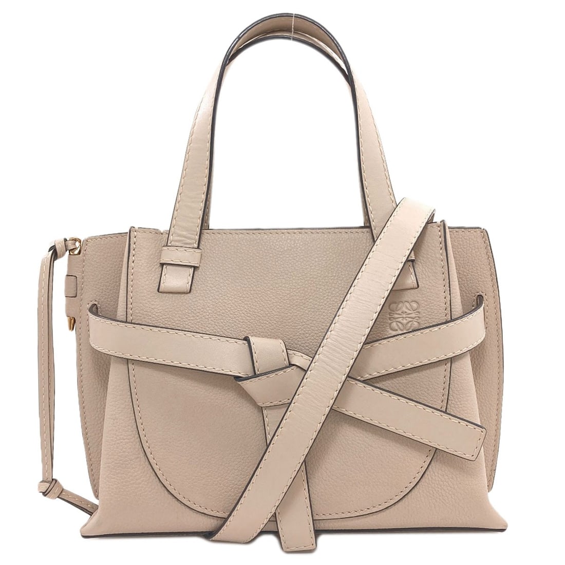 Calf Gate Mini Handbag Top Loewe 2Way: Calf Gate Mini Handbag Top Loewe 2Way This LOEWE Calf Gate Mini Handbag Top Loewe features a beige exterior and a unique 2-way design. Measuring 7.1 inches in height and 9.8 inches in width, it has a
