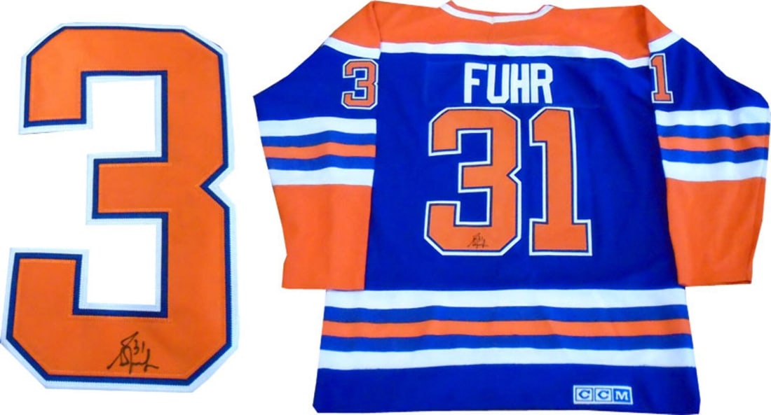 Fuhr Oilers Autographed Edmonton Jersey: Fuhr Oilers Autographed Edmonton Jersey Grant Fuhr's Edmonton Oilers jersey bears his signature on the back number in black sharpie, a nod to his time as the best goalie in the world in the 1980s.
