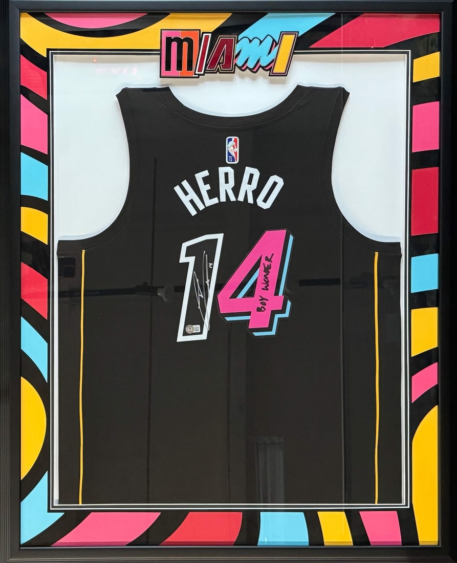 Miami Heat Jersey Autographed Framed Mash Up By Tyler Herro: Miami Heat Jersey Autographed Framed Mash Up By Tyler Herro Tyler Herro's silver and black sharpie signature on the back of this Miami Heat jersey reads "Boy Wonder" in bold letters. The jersey is fra
