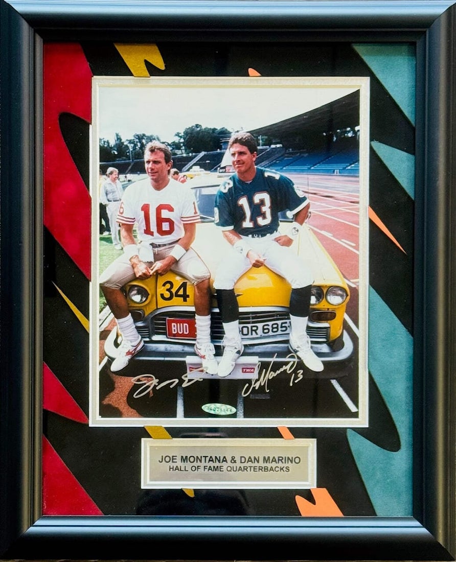 Joe Montana & Dan Marino Autographed Framed 8x10 Photo (UDA): Joe Montana & Dan Marino Autographed Framed 8x10 Photo (UDA) Joe Montana and Dan Marino's iconic likenesses are captured in this 8x10 framed photo, bearing the signatures of the two legendary NFL quar