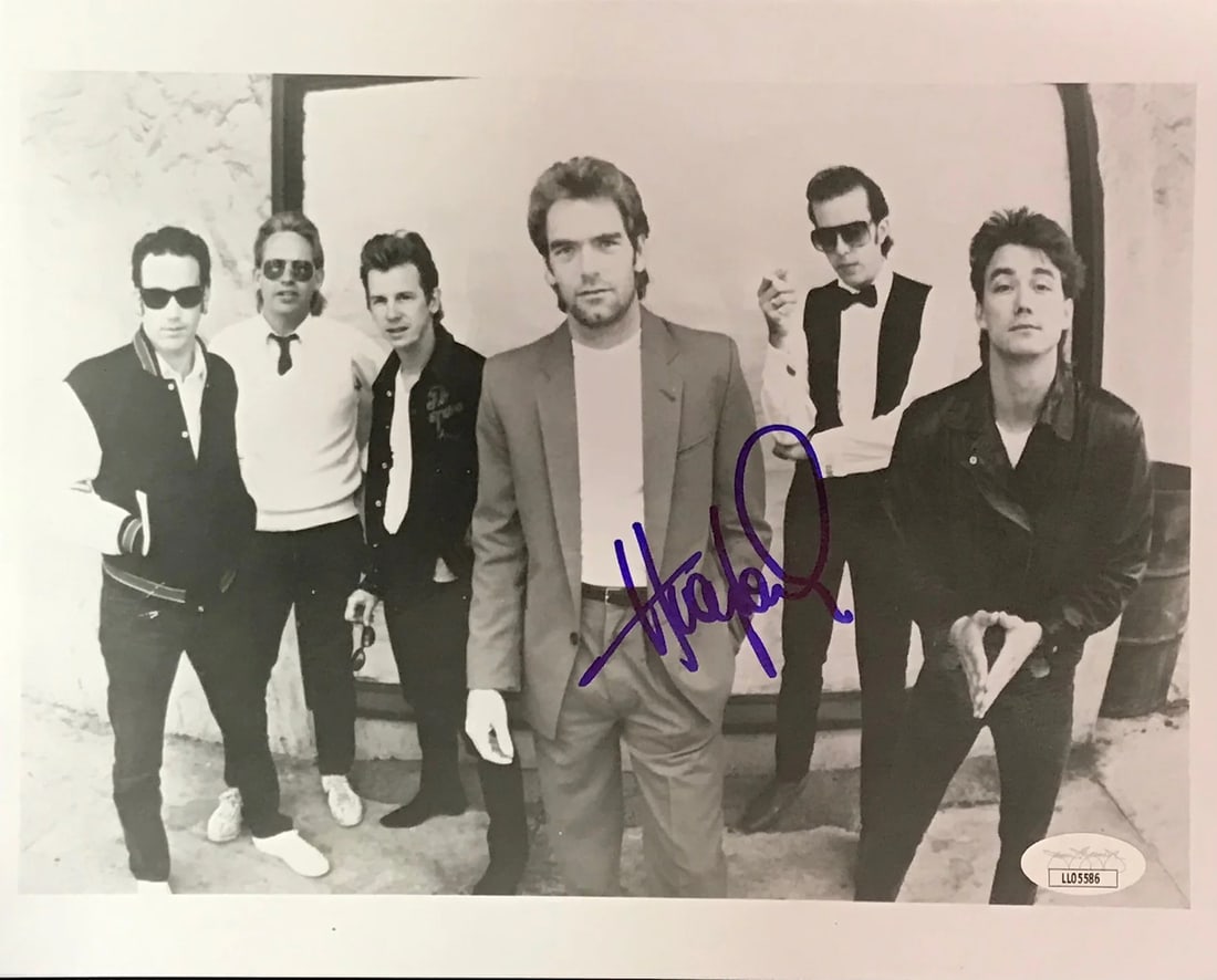 Huey Lewis Autographed 8x10 Photo (JSA): Huey Lewis Autographed 8x10 Photo (JSA) Authentic Cyndi Lauper signed 8x10 photo, bearing a blue sharpie signature across the front, verified by James Spence Authentication (JSA). This photo is a uniq