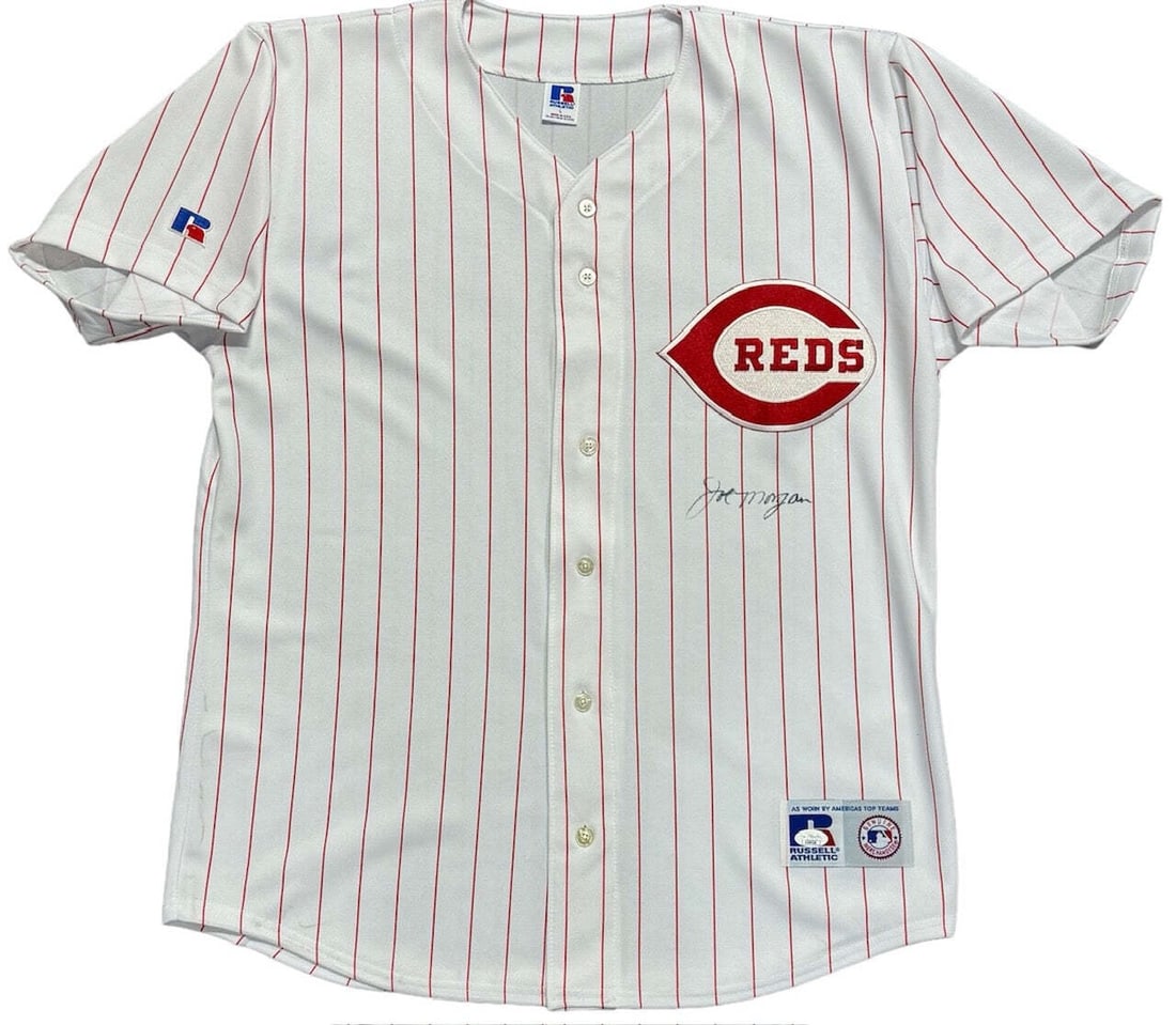 Joe Morgan Autographed Reds Russell Athletic Jersey (JSA): Joe Morgan Autographed Reds Russell Athletic Jersey (JSA) Joe Morgan's iconic black Sharpie signature adorns the front of this authentic 1970s-era Cincinnati Reds Russell Athletic jersey, a true piece
