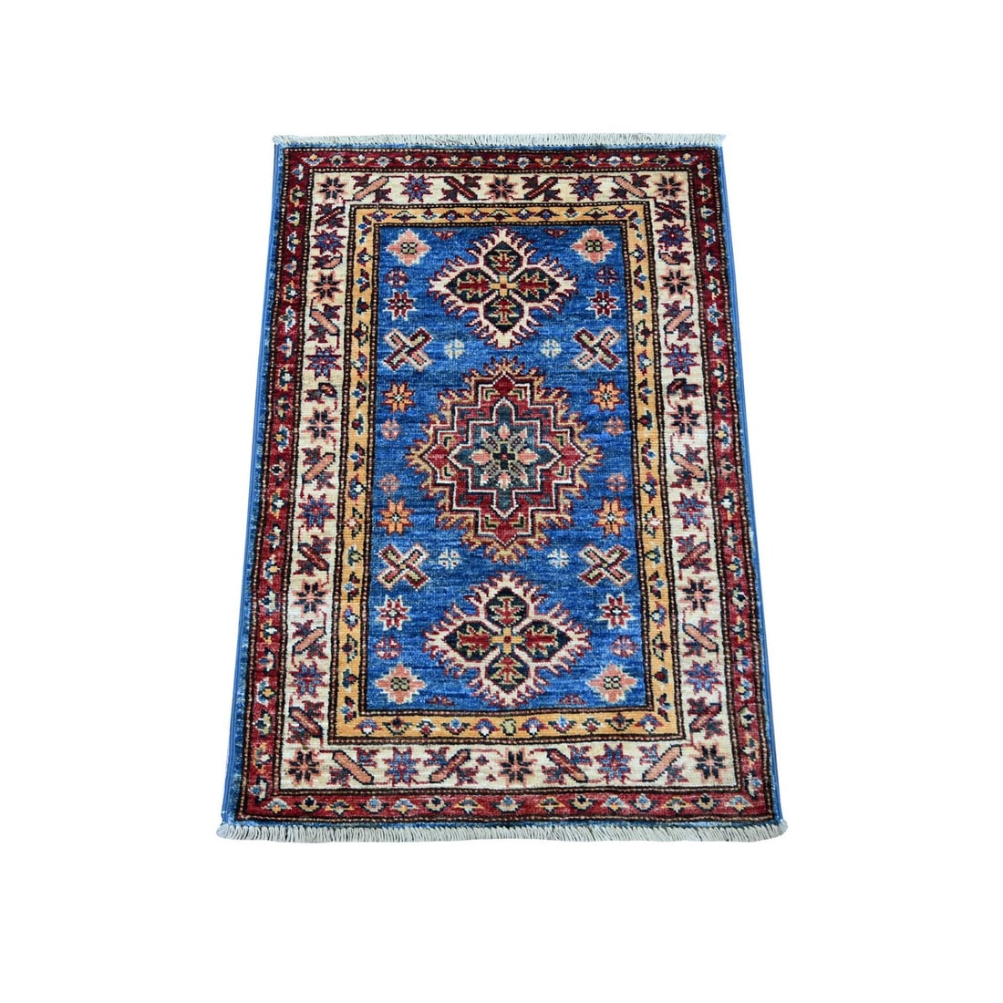 Blue Super Kazak 2'x2'10" Hand Knotted Pure Wool Mat Rug: Blue Super Kazak 2'x2'10" Hand Knotted Pure Wool Mat Rug The Blue Super Kazak 2'x2'10" Hand Knotted Pure Wool Mat Rug boasts a stunning medallion pattern in a rich blue field, set against a subtle ivo