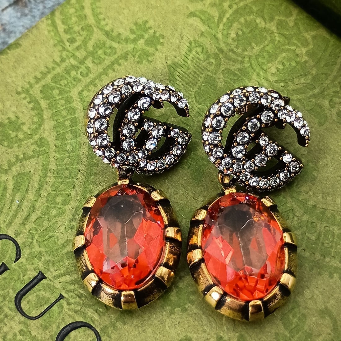Gucci GG Double G Red Stone Dangle Earring with Original Box: Gucci GG Double G Red Stone Dangle Earring with Original Box Item Specifics: Brand: Gucci Type: Earring Closure: Stud Color: Gold Style: Dangle Main Stone Color: Red Material: Metal Main Stone: Clored