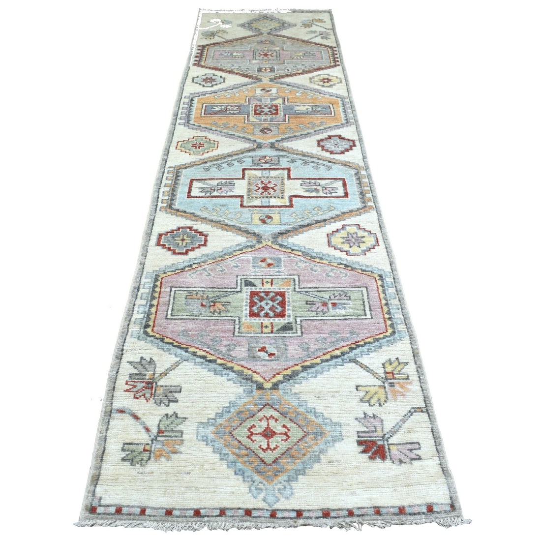 Hand knotted gray Anatolian village inspired wool wide runner rug: Hand knotted gray Anatolian village inspired wool wide runner rug Hand-knotted in traditional Afghan style, this 3'0" x 12'0" gray Anatolian village inspired wool wide runner rug boasts a stunning fie