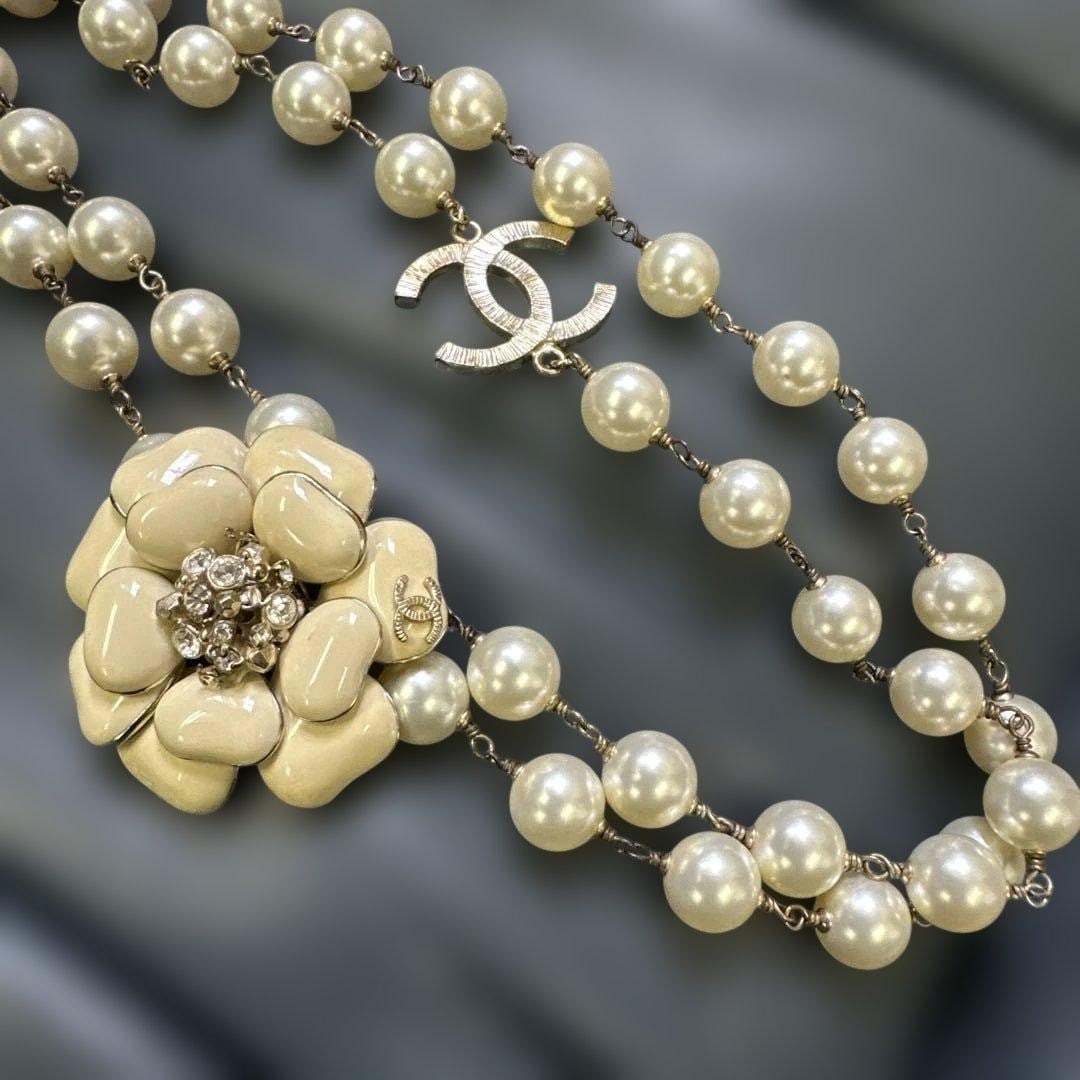 CHANEL 10A Camellia Motif Coco Mark CC Faux Pearl Double-Strand Necklace in Rare: CHANEL 10A Camellia Motif Coco Mark CC Faux Pearl Double-Strand Necklace in Rare Item Specifics: Brand: CHANEL Type: Necklace Style: necklace Material: Metal Metal: Gold Plated Main Stone: Faux Pearl 
