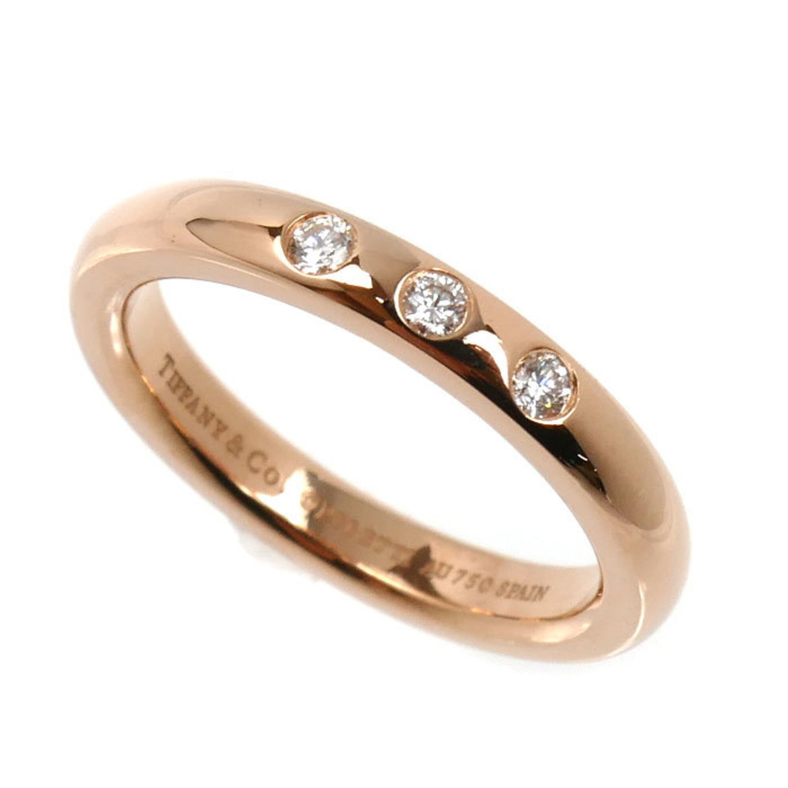 TIFFANY Band Ring Pink Gold (18K): TIFFANY Band Ring Pink Gold (18K) Pink gold (18K) band ring from Tiffany, featuring a diamond stone. Gently used with minor signs of wear, this ring is in very good condition, bearing a small scratch