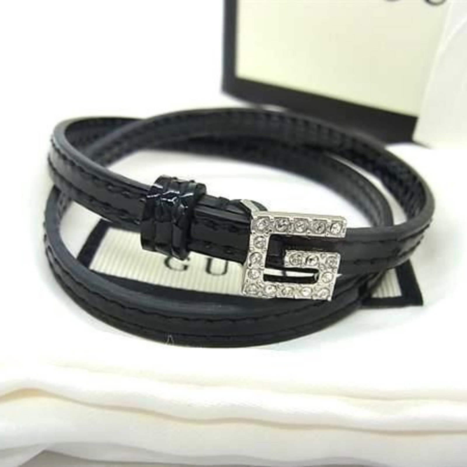 GUCCI Charm Bracelet Patent Leather: GUCCI Charm Bracelet Patent Leather Patent leather charm bracelet from Gucci, featuring a black stone and rhinestone accents, measures 33.8-34.8cm in length and 6mm in width. This like new used