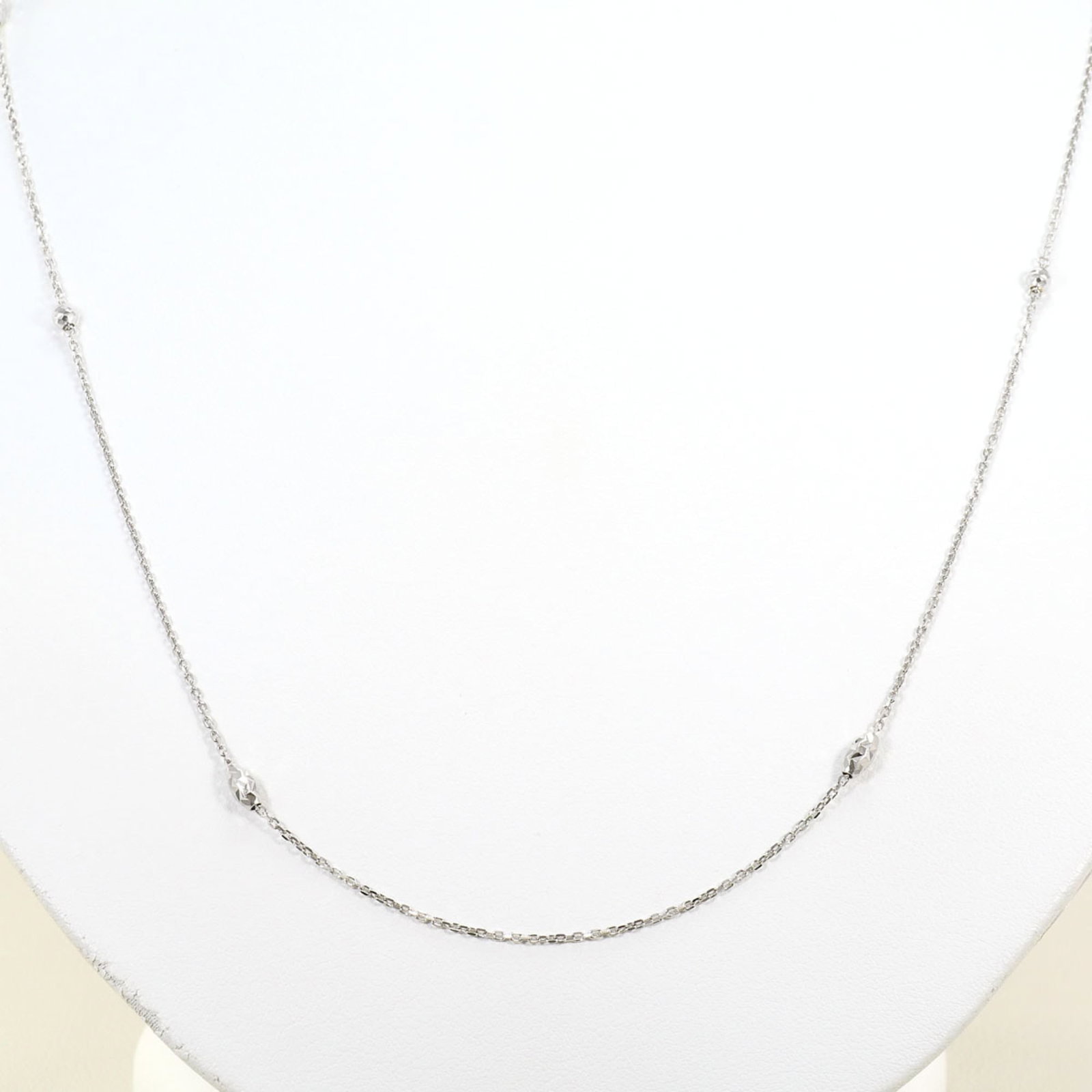 White Gold (18K): White Gold (18K) White gold (18K) necklace with a sleek, modern design. Made from high-quality 18K white gold, this necklace boasts a durable and luxurious feel. Its slender profile and elegant style