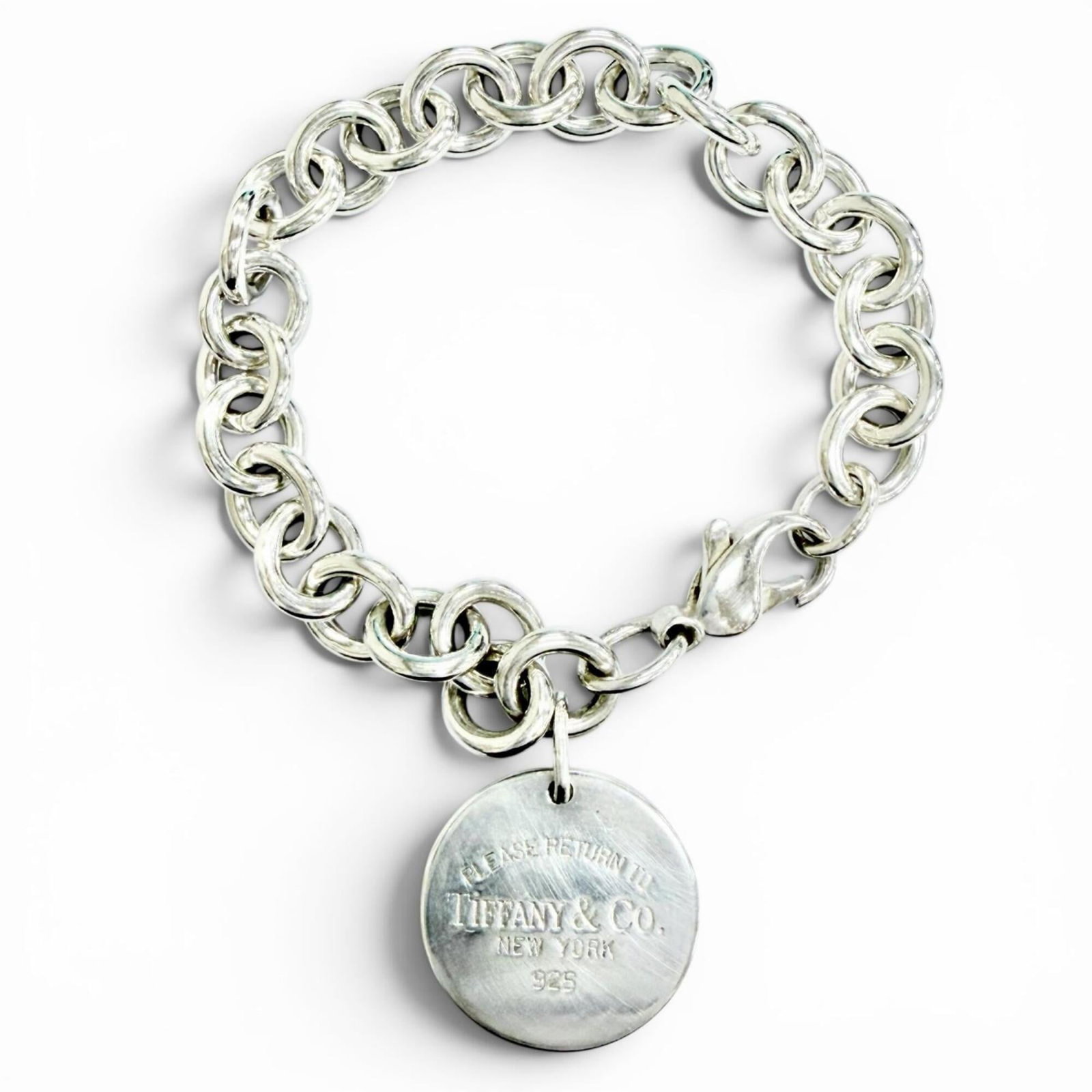 TIFFANY Charm Bracelet Silver 925: TIFFANY Charm Bracelet Silver 925 Silver 925 charm bracelet from Tiffany, featuring a delicate and elegant design, measures 18cm in length. The bracelet has undergone minor wear, with small scratches