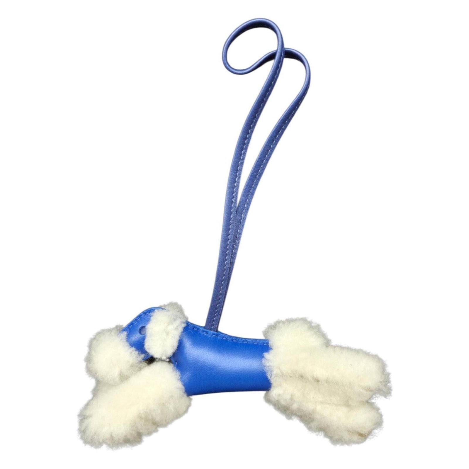 HERMES Handbag Charm Agneau Milo Leather: HERMES Handbag Charm Agneau Milo Leather Agneau Milo Leather Mouton charm from the iconic Hermes brand, featuring a striking blue and white color combination. This gently used charm boasts a unique,
