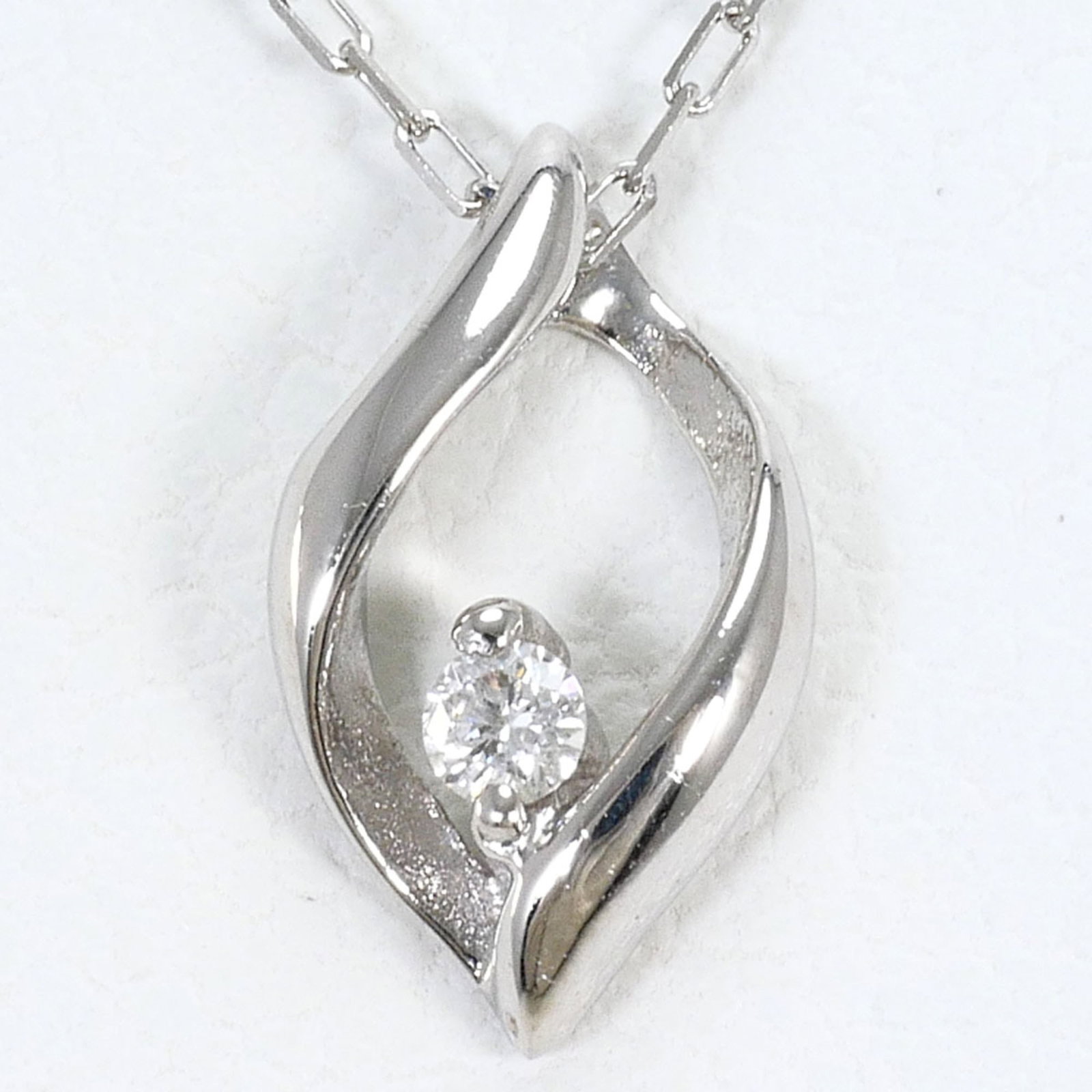 White Gold (10K): White Gold (10K) White gold (10K) necklace with a 0.02ct diamond pendant, measuring 9mm x 5mm, features a 40cm chain circumference. Made from 10K white gold, this necklace is in like new condition,