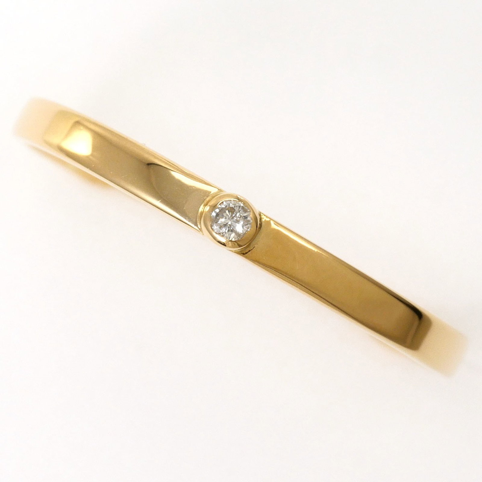 Band Ring Yellow Gold (18K): Band Ring Yellow Gold (18K) Yellow gold 18K band ring with a delicate 2mm diamond accent adds a touch of elegance to any outfit. Made from high-quality 18K yellow gold, this ring is both durable and v