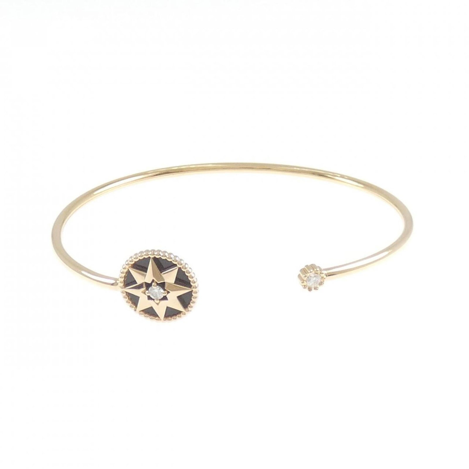 CHRISTIAN DIOR Bangle Pink Gold (18K): CHRISTIAN DIOR Bangle Pink Gold (18K) Pink gold (18K) bangle from Christian Dior, featuring a diamond and onyx stone, measures 15.5cm in length. The bangle is in very good condition, with minor signs