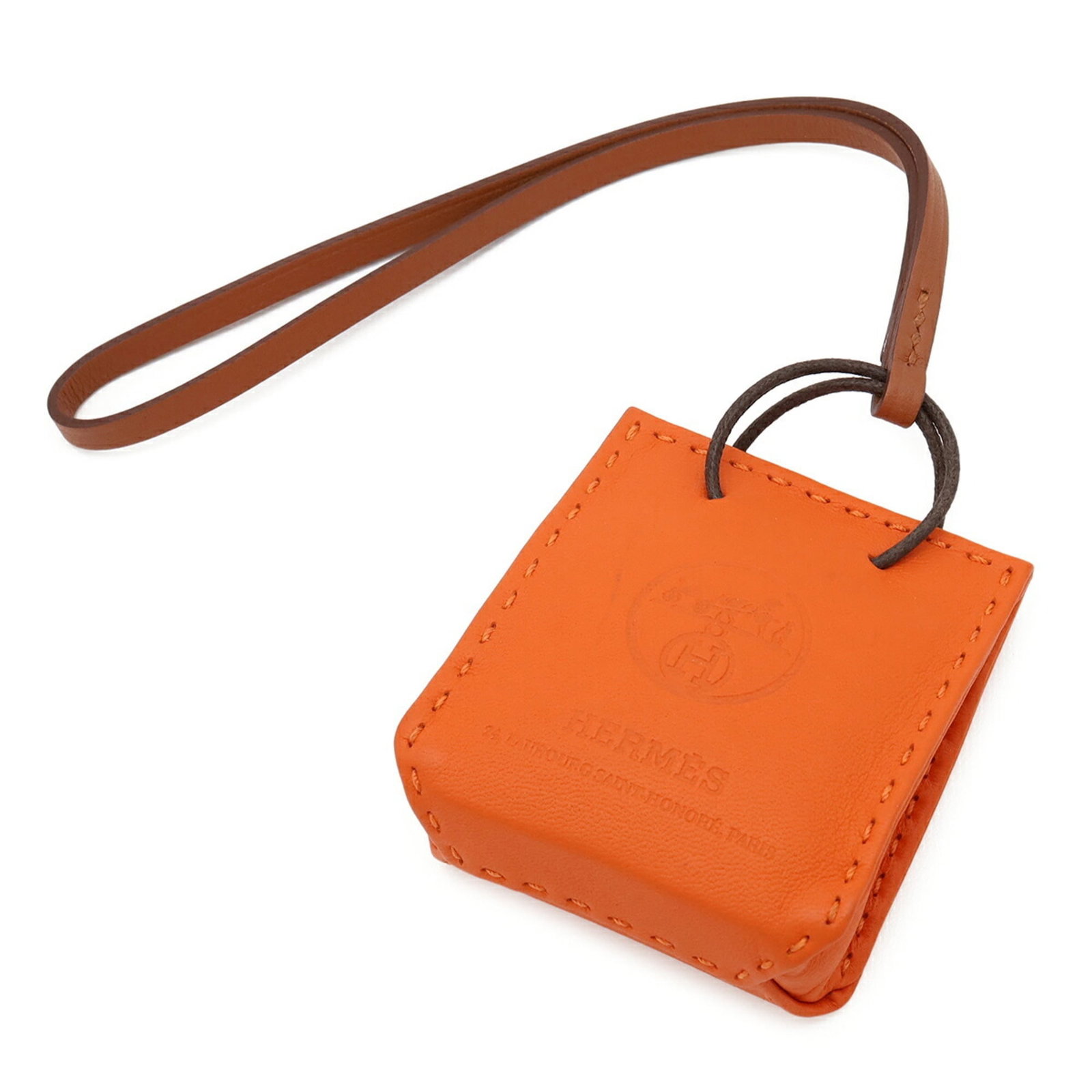 HERMES Handbag Charm Agneau Milo Swift Leather: HERMES Handbag Charm Agneau Milo Swift Leather Agneau Milo Swift Leather Handbag Charm from Hermes. This vibrant orange charm features a unique design made from high-quality Agneau Milo and Swift