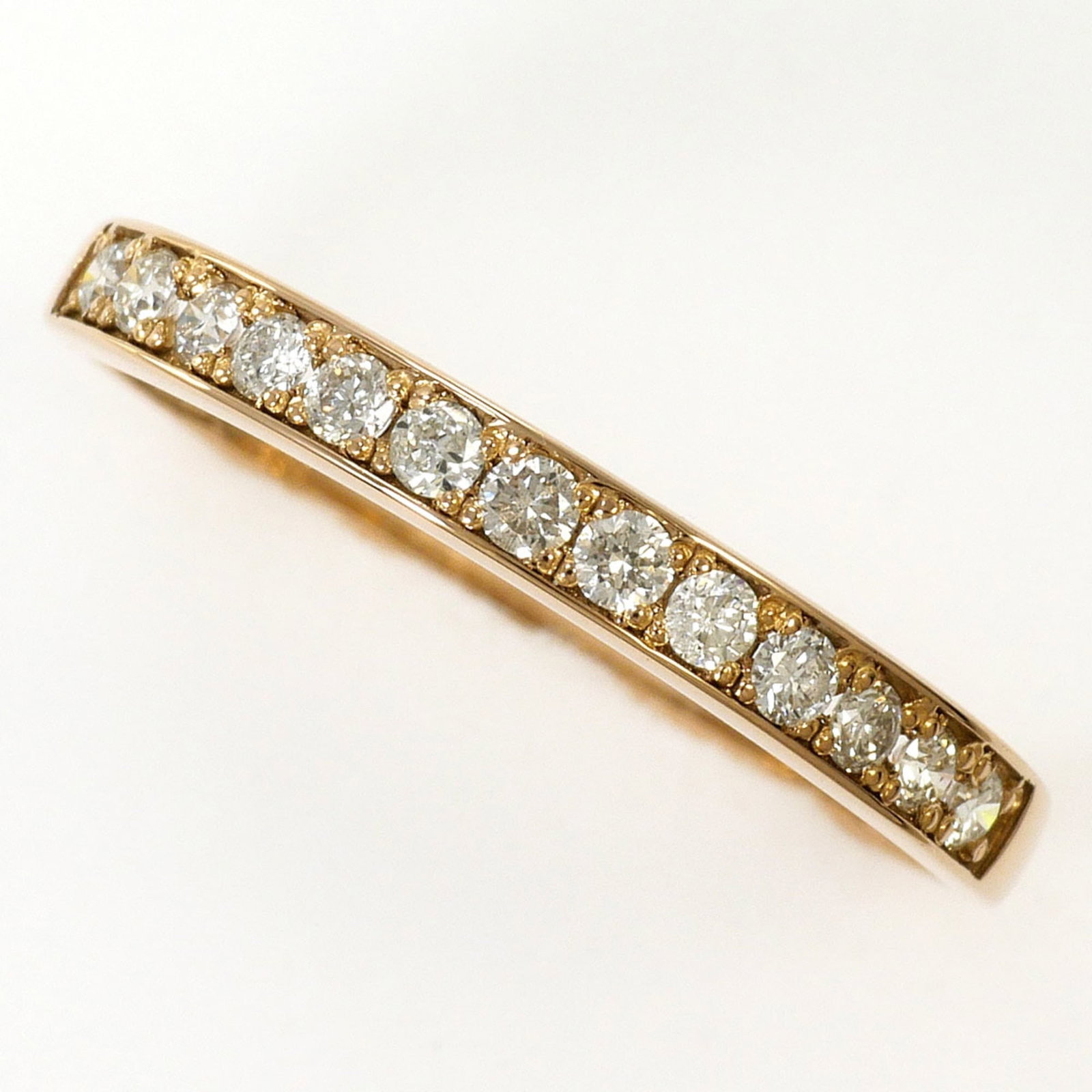 Band Ring Pink Gold (18K) Silver: Band Ring Pink Gold (18K) Silver Pink gold (18K) band ring with a subtle silver accent, available in a US size 6.5. This 2mm wide band features a diamond stone and is made from 18K pink gold and silve