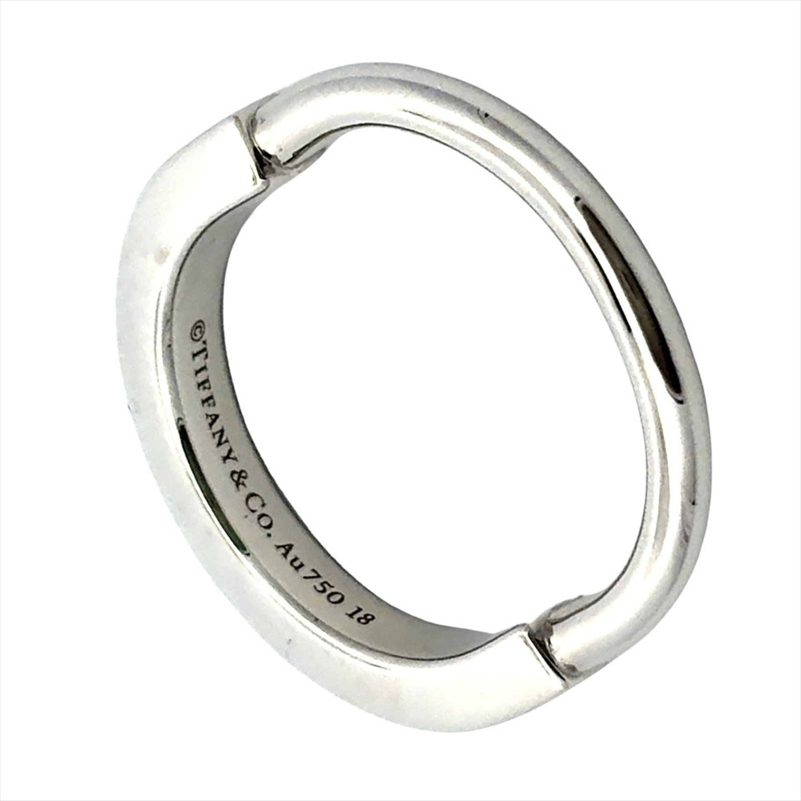 TIFFANY Band Ring White Gold (18K): TIFFANY Band Ring White Gold (18K) This 18K white gold band ring from Tiffany is a timeless piece, featuring a sleek design that exudes elegance. Made from high-quality white gold, it is in like new c
