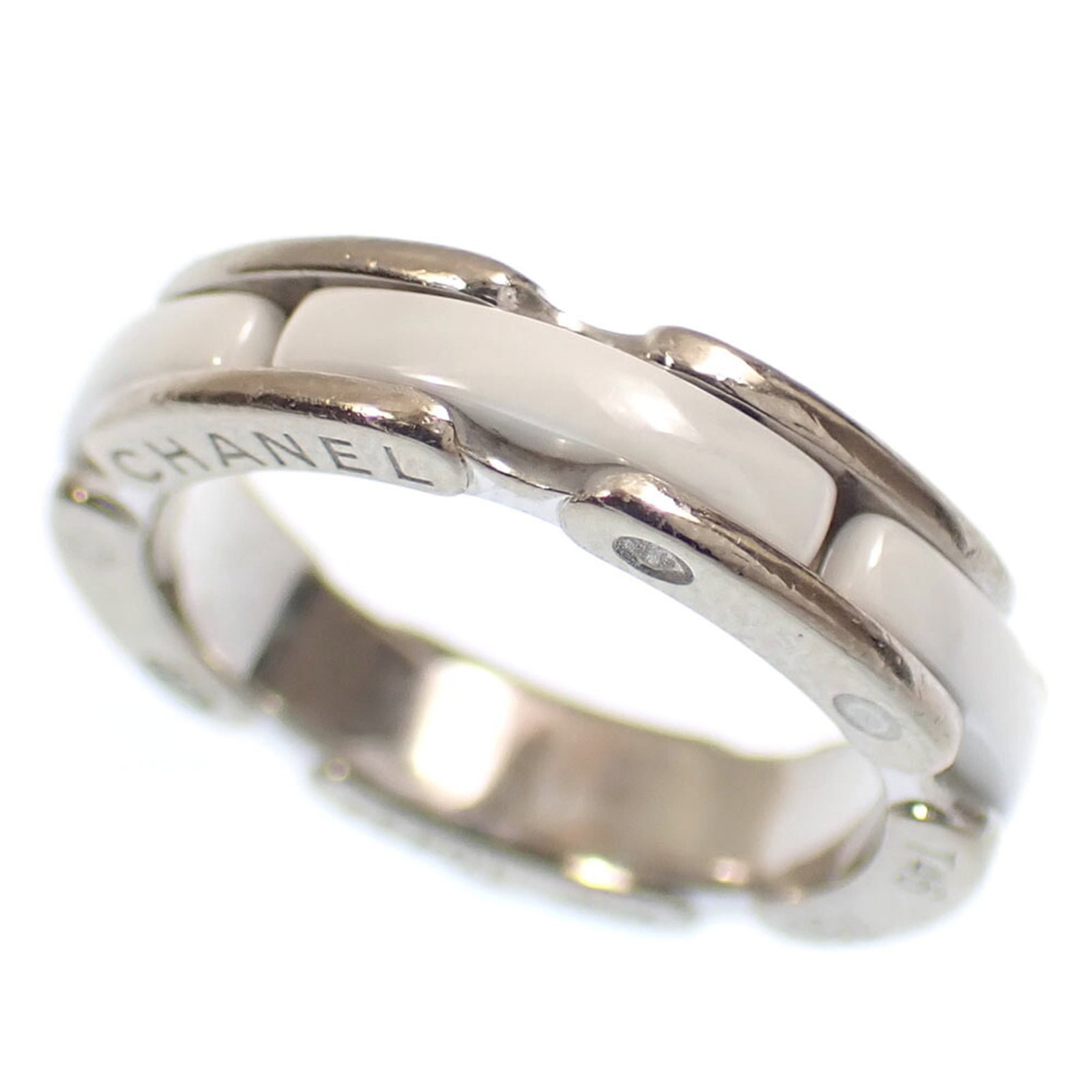CHANEL Band Ring White Gold (18K): CHANEL Band Ring White Gold (18K) This 18K white gold band ring from CHANEL features a sleek design with a subtle presence. With visible scratches and scuffs, it showcases a worn-in quality that adds