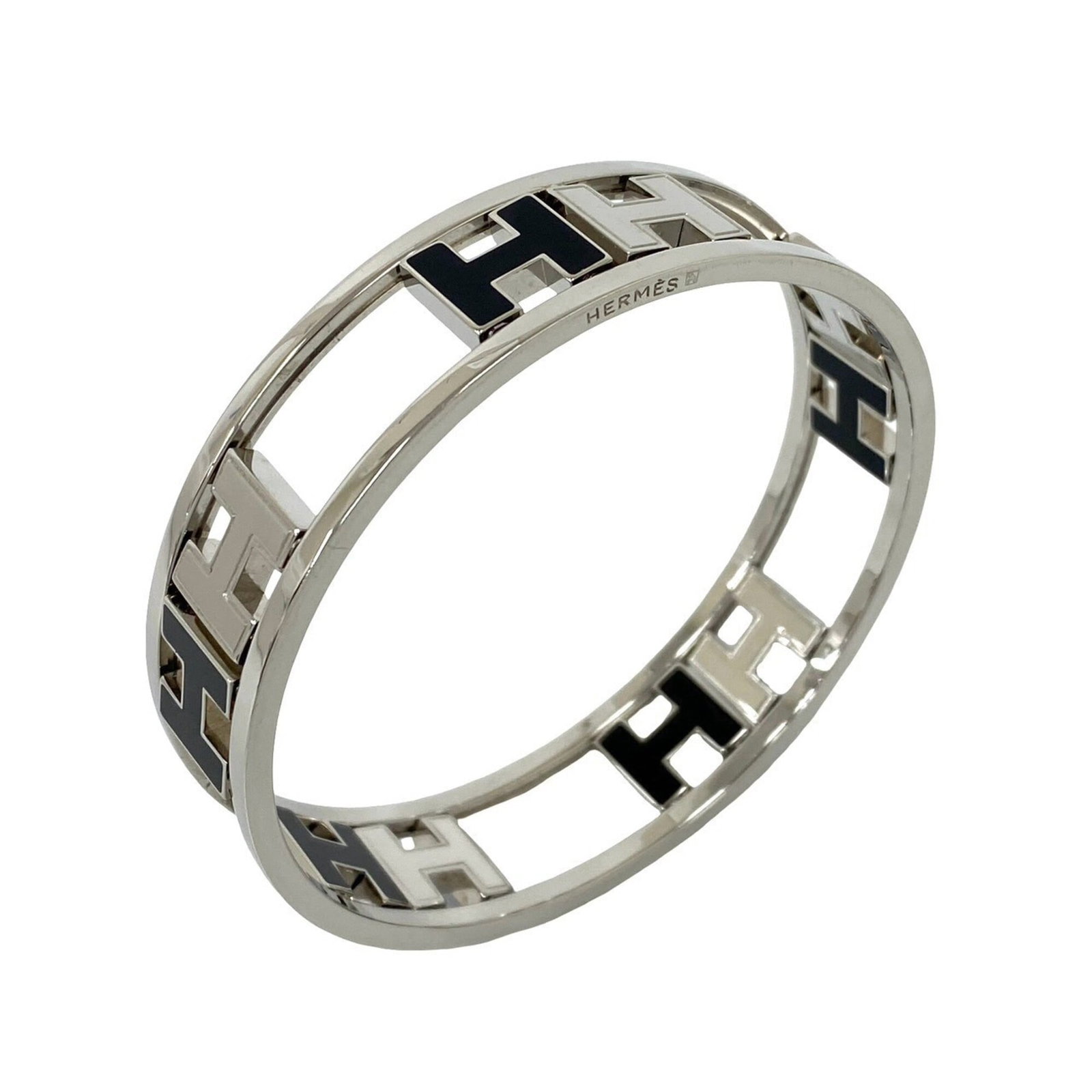 HERMES Bangle Metal: HERMES Bangle Metal Black and silver metal bangle from Hermes, measuring 19cm in length, with visible scratches and scuffs. The item is in good used condition, bearing a signature. Item Specifics: