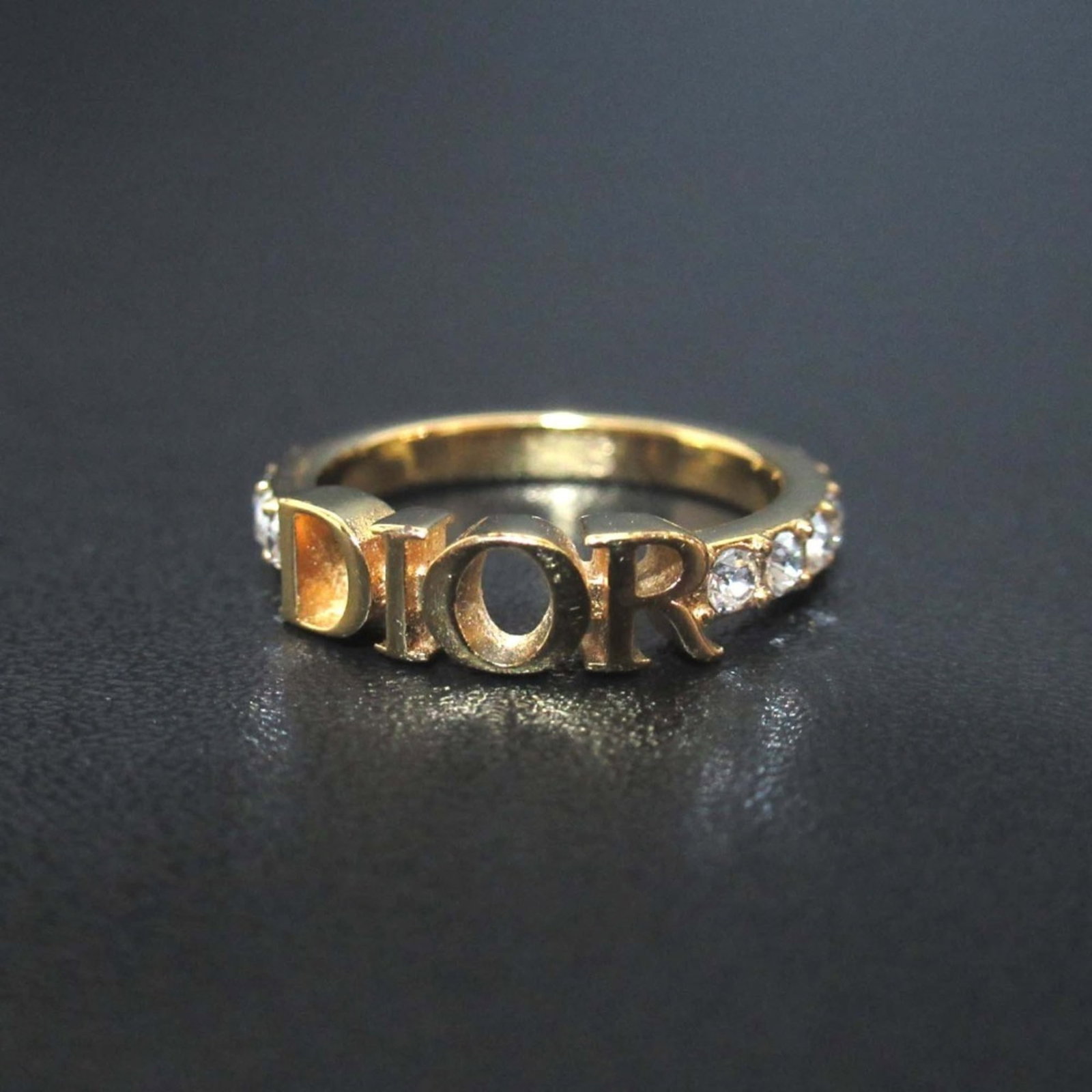 CHRISTIAN DIOR Band Ring Gold: CHRISTIAN DIOR Band Ring Gold Gold band ring from Christian Dior, a high-end fashion brand, is available. This 6 US size band ring is made of gold and comes with a box and dust bag. In like new condit