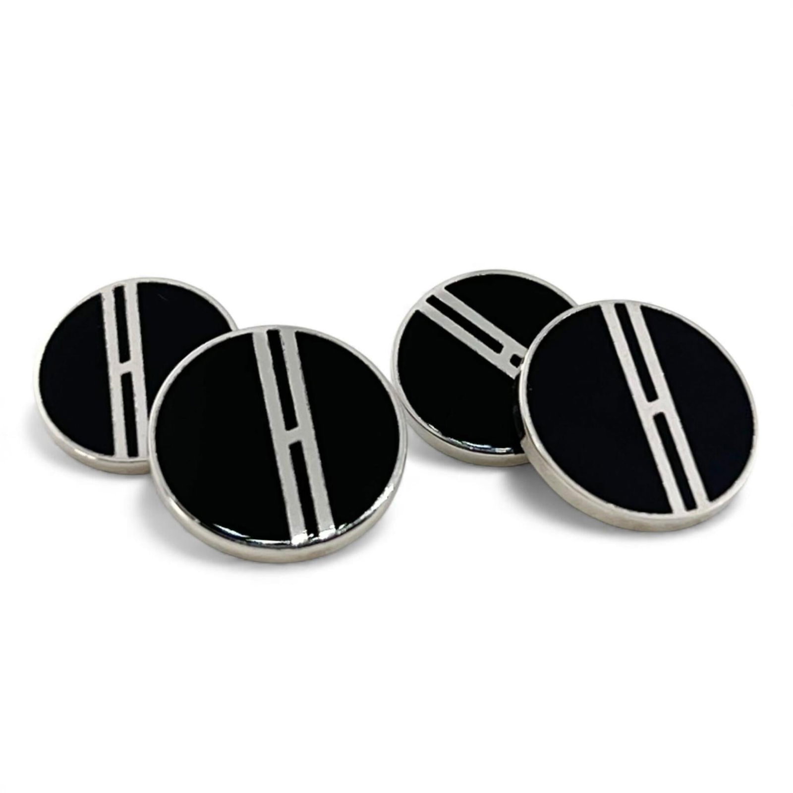 HERMES Stud/Button Enamel: HERMES Stud/Button Enamel Stud/button enamel from the renowned French fashion house Hermes, featuring a sleek black and silver design. The item boasts a diameter of 1.3mm and a chain/post length of 1.