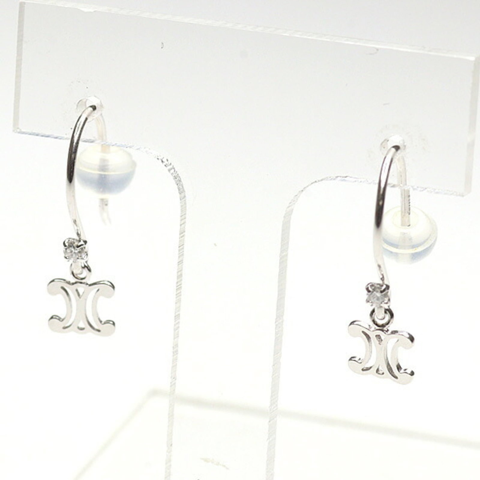 CELINE Drop Earrings White Gold (10K): CELINE Drop Earrings White Gold (10K) White gold (10K) drop earrings from Celine feature a diamond stone, measuring 5.10mm x 4.60mm. The earrings showcase visible wear, including scratches and