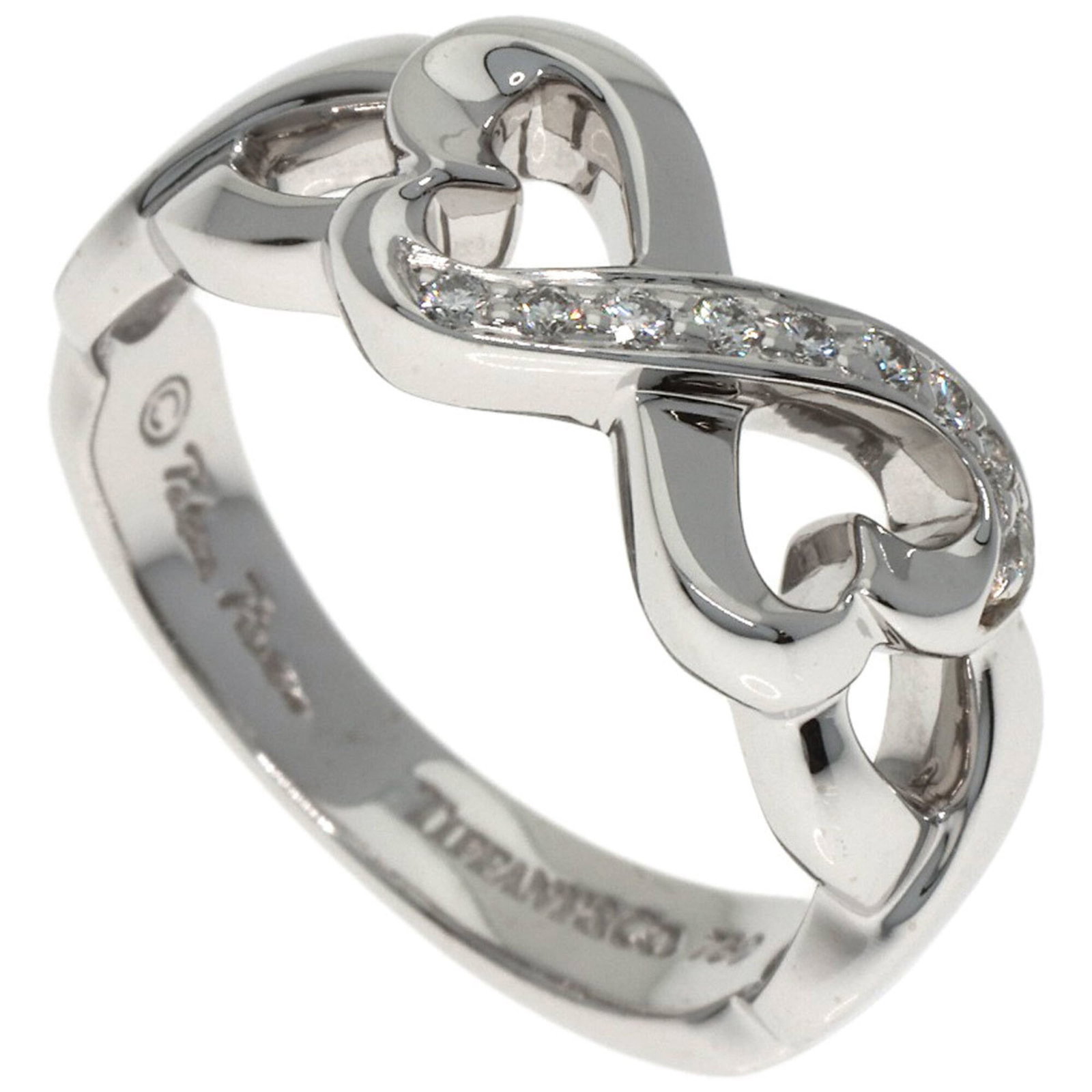 TIFFANY Band Ring: TIFFANY Band Ring 18K White Gold Band Ring with Diamond. This gently used Tiffany band ring features a diamond stone and is made of 18K white gold. With a small scratch or light mark, this item is in 