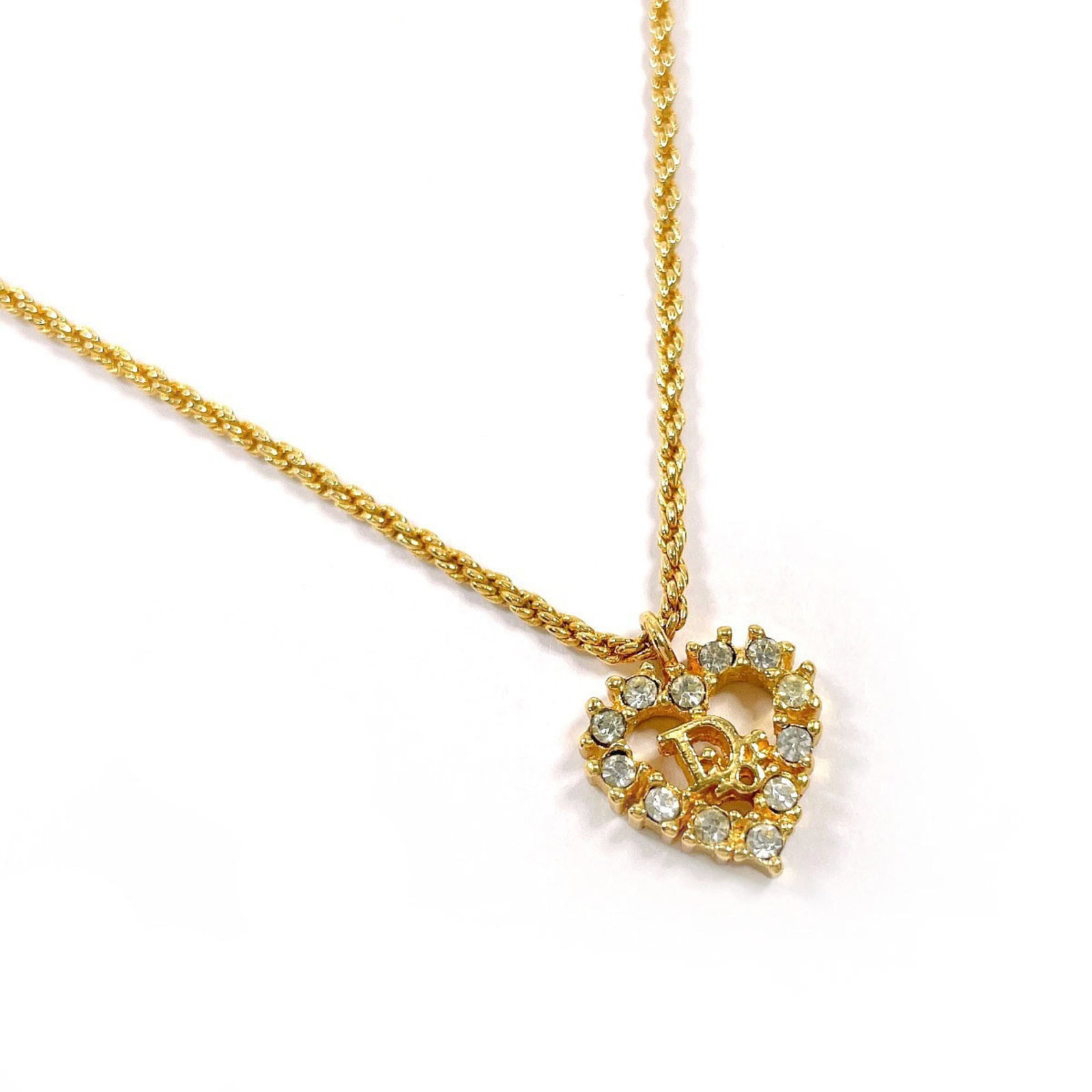 CHRISTIAN DIOR Metal Rhinestone: CHRISTIAN DIOR Metal Rhinestone Metal Rhinestone Necklace from Christian Dior, featuring a gold pendant with a 15.3mm x 13mm rhinestone design, measures 44.5 cm in length and 0.6'' x 0.51'' in size,