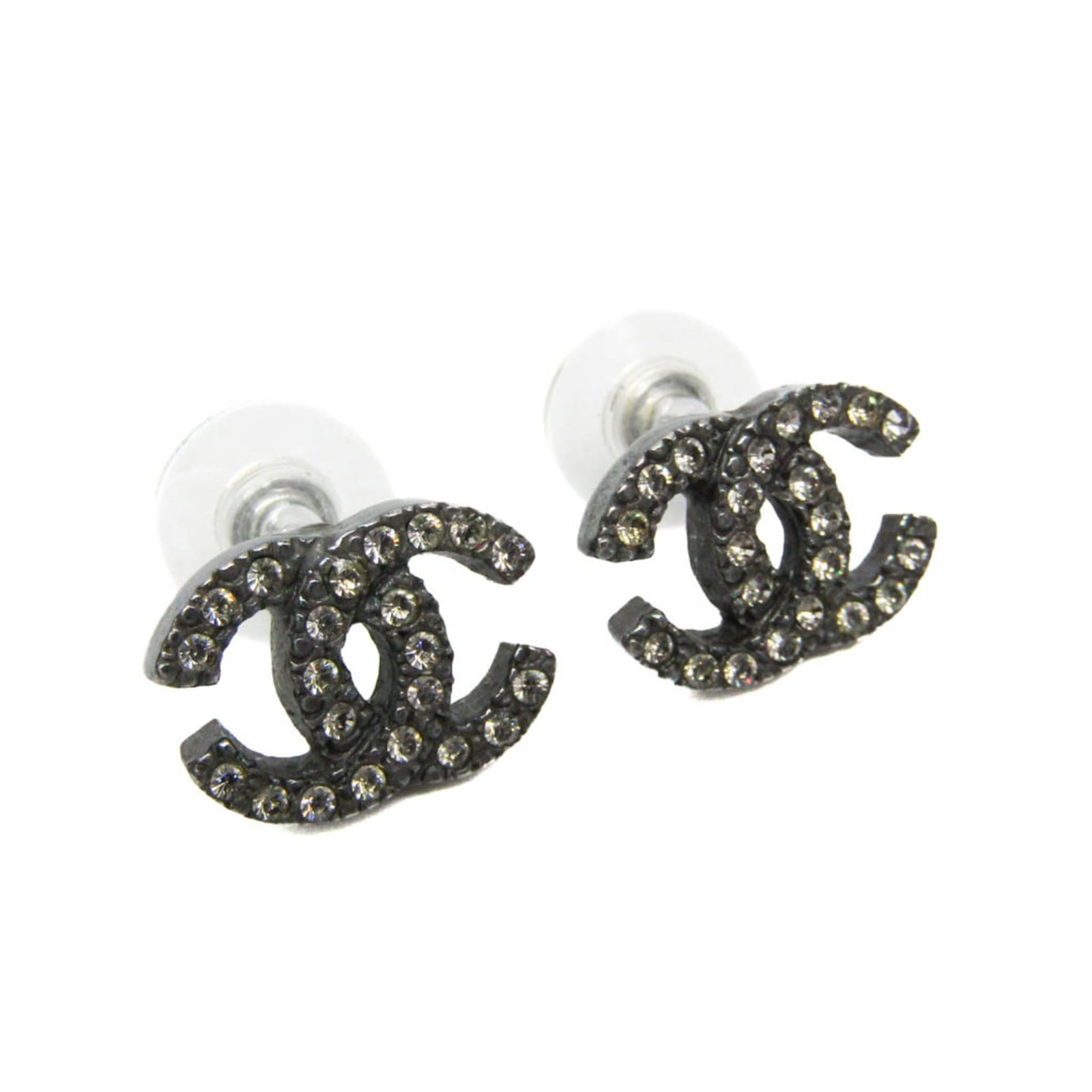 CHANEL Stud Earrings Metal: CHANEL Stud Earrings Metal Stud earrings from the iconic CHANEL line, crafted in gunmetal metal and adorned with rhinestones, add a touch of understated elegance to any outfit. Gently used with minor