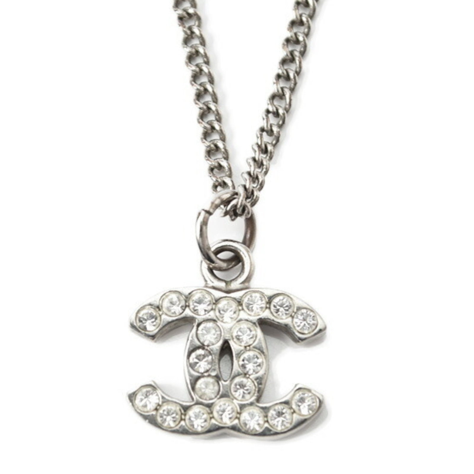 CHANEL Metal Silver: CHANEL Metal Silver Silver Chanel Metal Necklace with Rhinestone Pendant. This elegant necklace features a 42 cm chain and a 11mm x 14mm rhinestone pendant, set in a metal frame. Gently used with