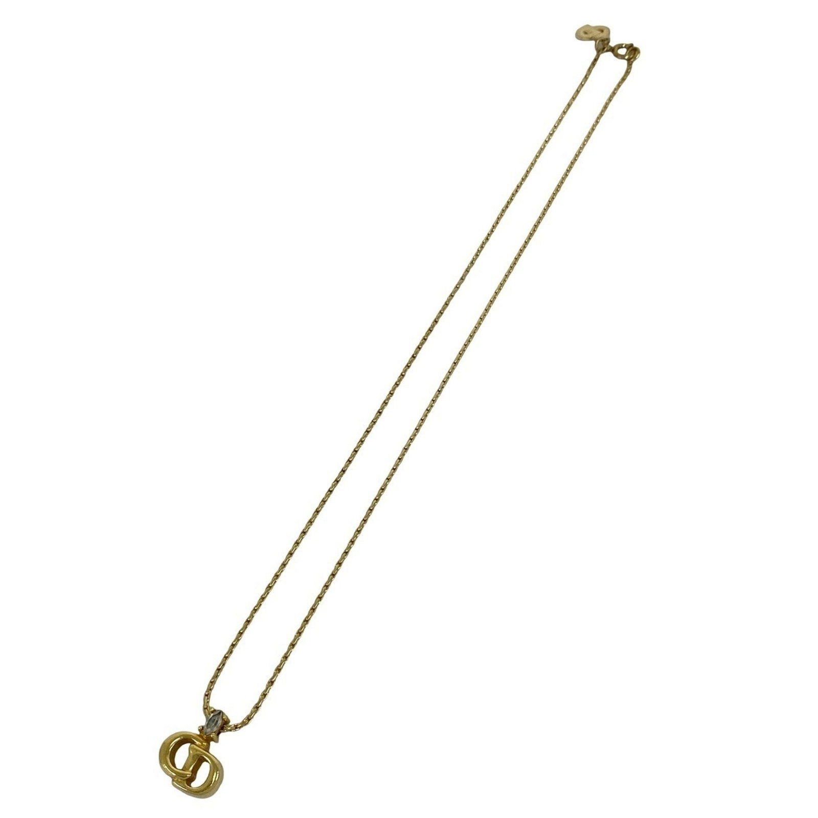 CHRISTIAN DIOR Gold Plating: CHRISTIAN DIOR Gold Plating Gold plating from Christian Dior adds a touch of luxury to any outfit. This 39 cm necklace features a 15mm x 13mm pendant, showcasing a subtle gold finish. With visible