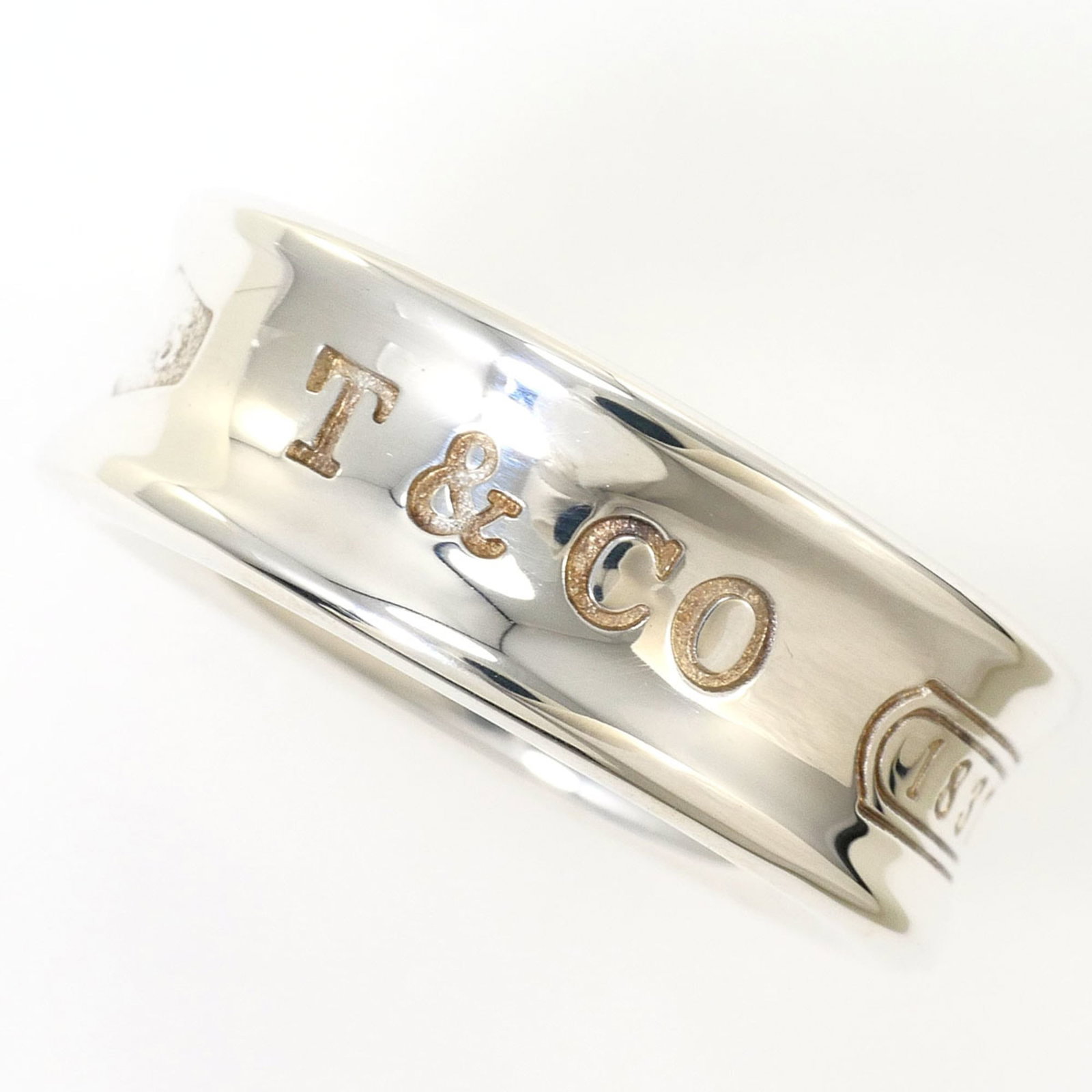 TIFFANY Band Ring Silver 925: TIFFANY Band Ring Silver 925 Silver 925 band ring from Tiffany's 1837 line, featuring a sleek 7mm width and a weight of 6.9g, making it a stylish and slender accessory. This like new used ring boasts 