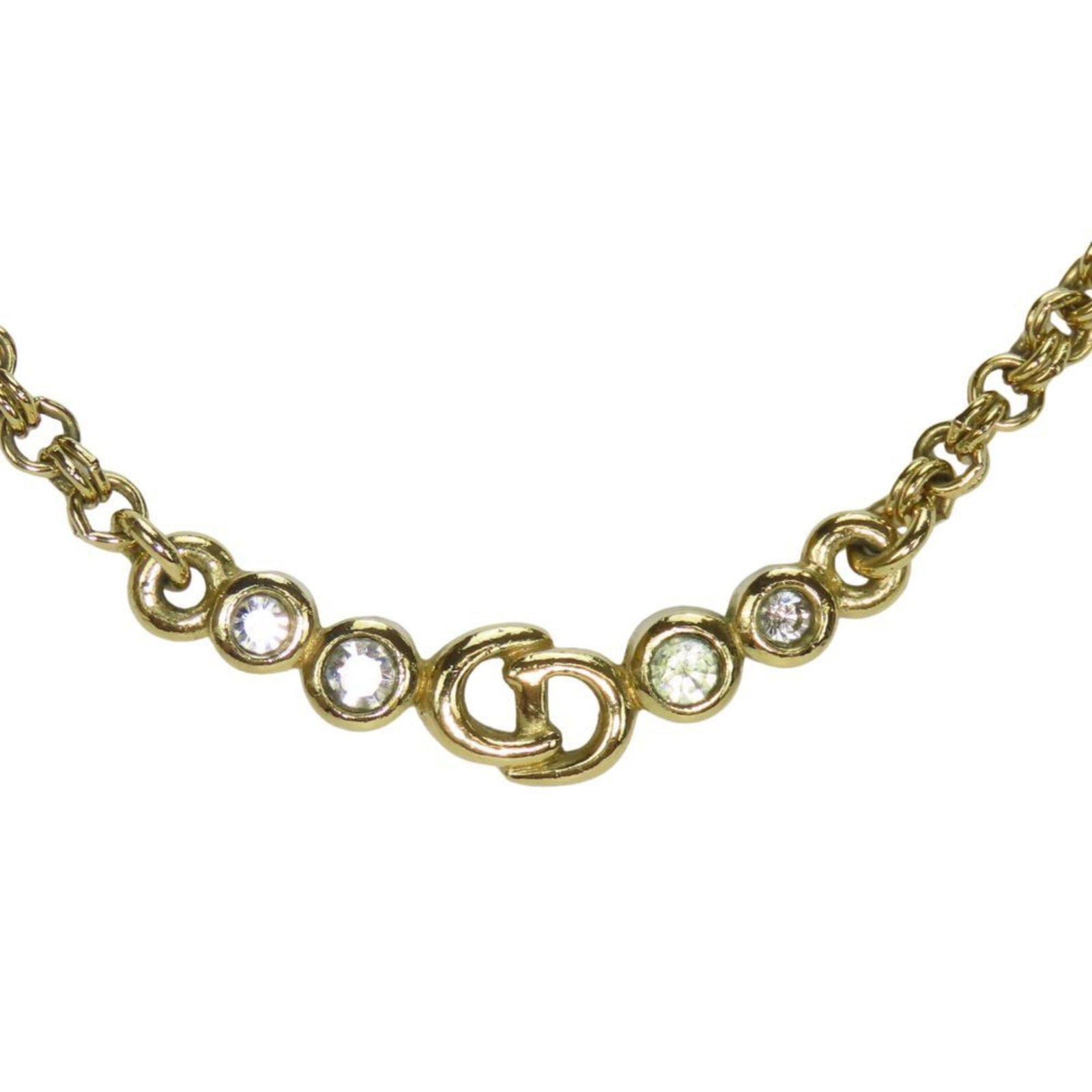 CHRISTIAN DIOR Metal: CHRISTIAN DIOR Metal Gold Rhinestone Christian Dior Metal Necklace. This 42.5 cm gold metal necklace features a 7mm x 33mm rhinestone pendant and is made from metal. The necklace comes with a box and