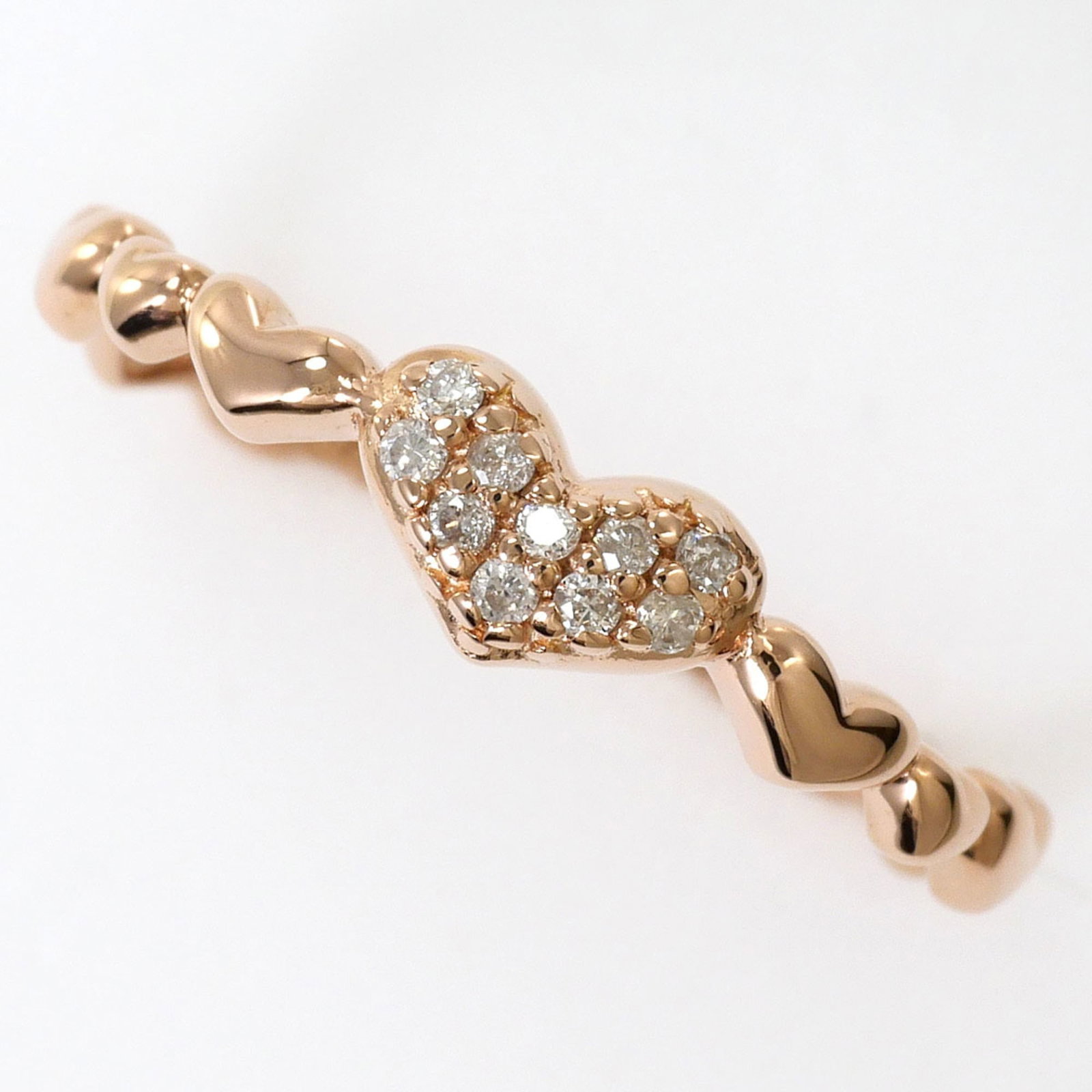 Band Ring Pink Gold (10K): Band Ring Pink Gold (10K) Pink gold 10K band ring with a subtle diamond accent, available in a US size 6. This elegant ring boasts a 4mm wide band, weighing 1g, and features a delicate pink gold metal