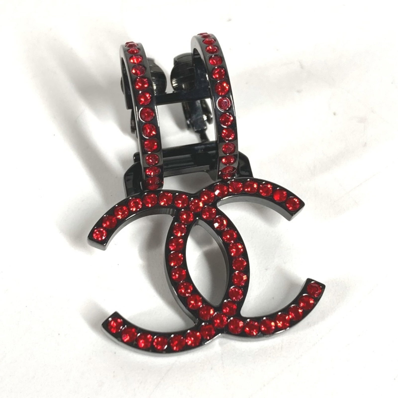 CHANEL Clip Earrings Metal: CHANEL Clip Earrings Metal Black and Red Chanel Clip Earrings with Crystal and Rhinestone Details, Gently Used in Very Good Condition. The earrings feature a sleek metal design with a subtle clip